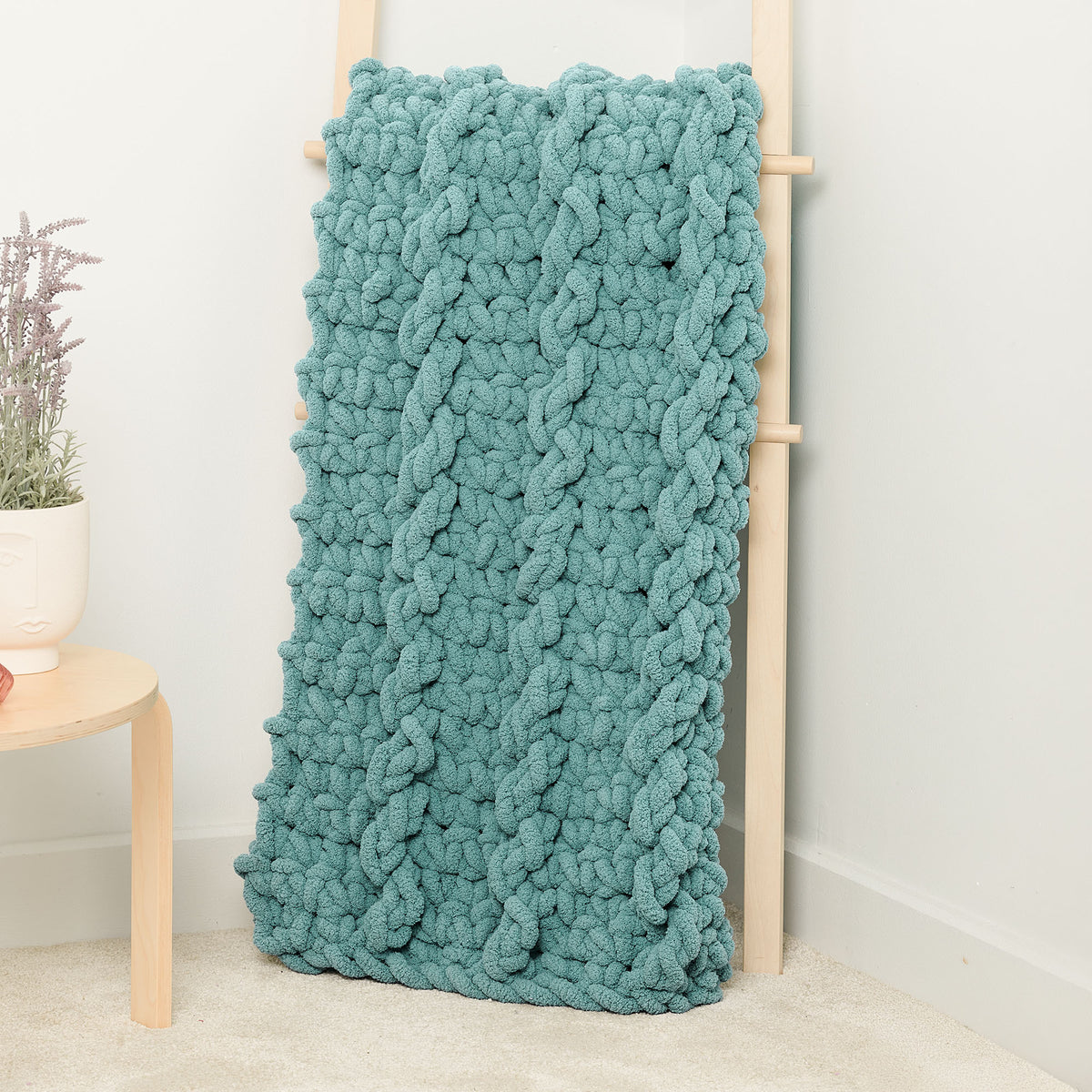 Big Mood Mock Cable Crochet Blanket made using Bernat yarn in a styled lifestyle setting