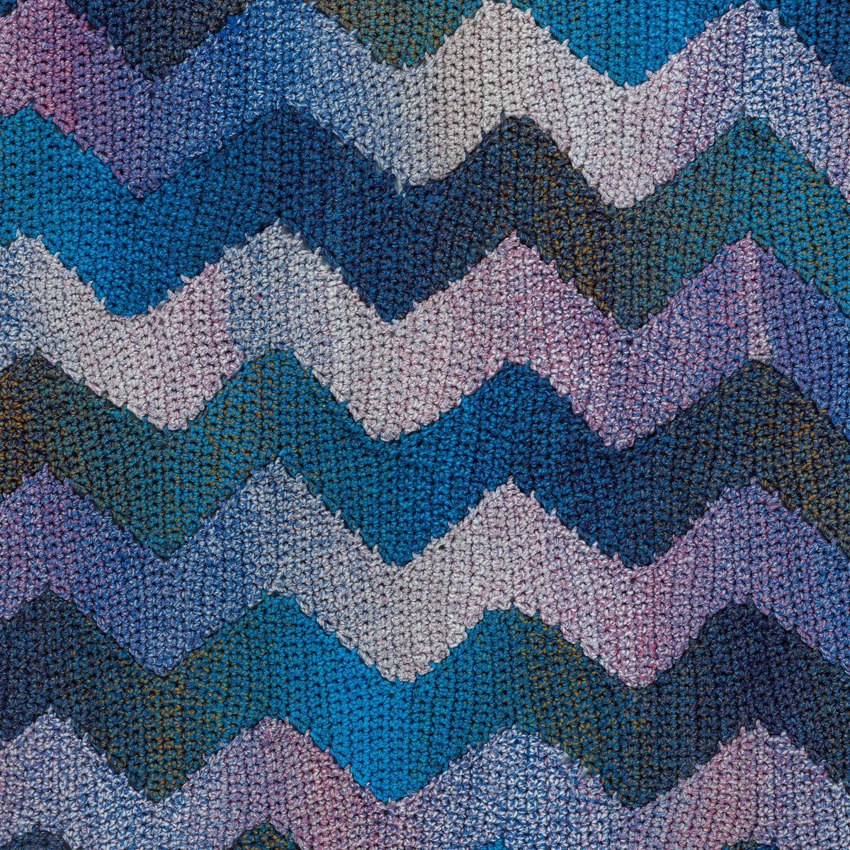 Join As You Zig Zag Crochet Blanket made using Bernat yarn in a styled lifestyle setting