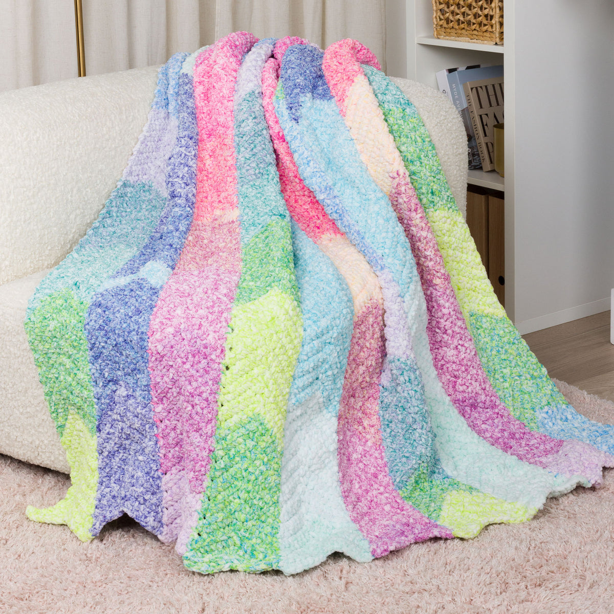 Color Cascade Crochet Blanket made using Bernat yarn in a styled lifestyle setting
