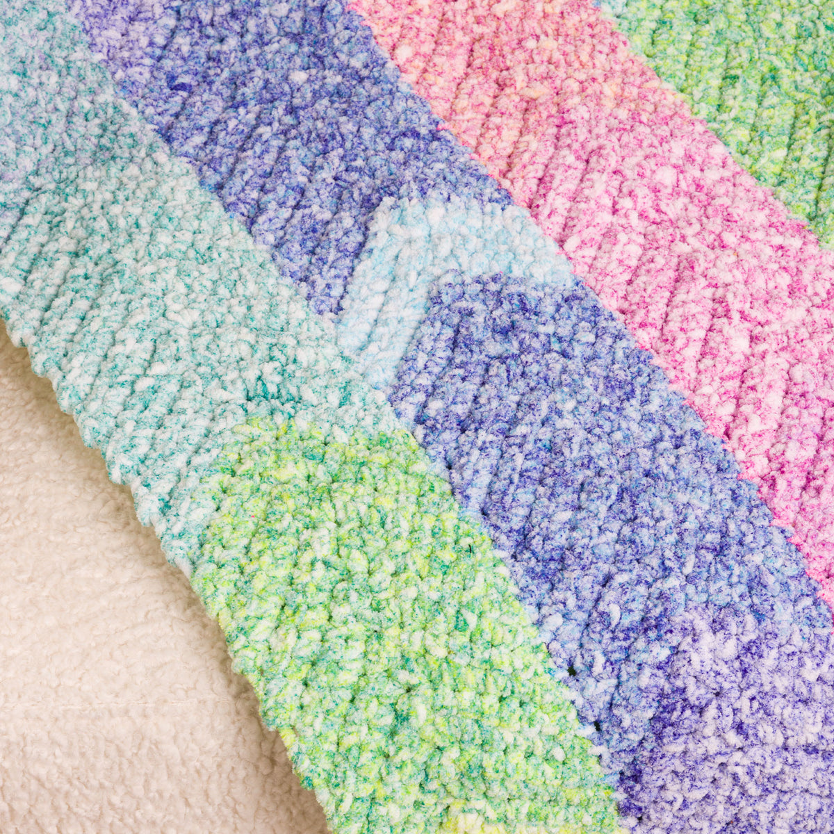 Color Cascade Crochet Blanket made using Bernat yarn in a styled lifestyle setting