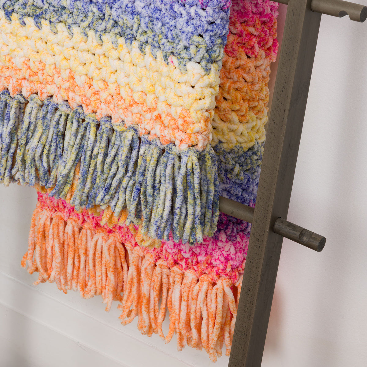 Morning Moss-Stitch Crochet Blanket made using Bernat yarn in a styled lifestyle setting