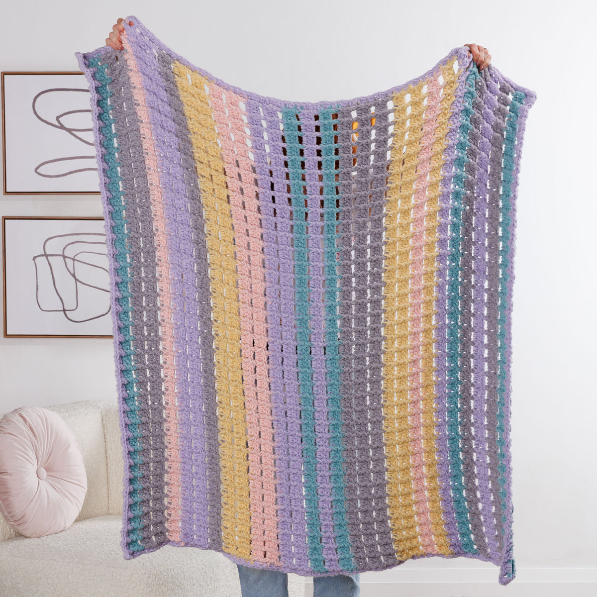 Suit Your Mood Crochet Blanket made using Bernat yarn in a styled lifestyle setting