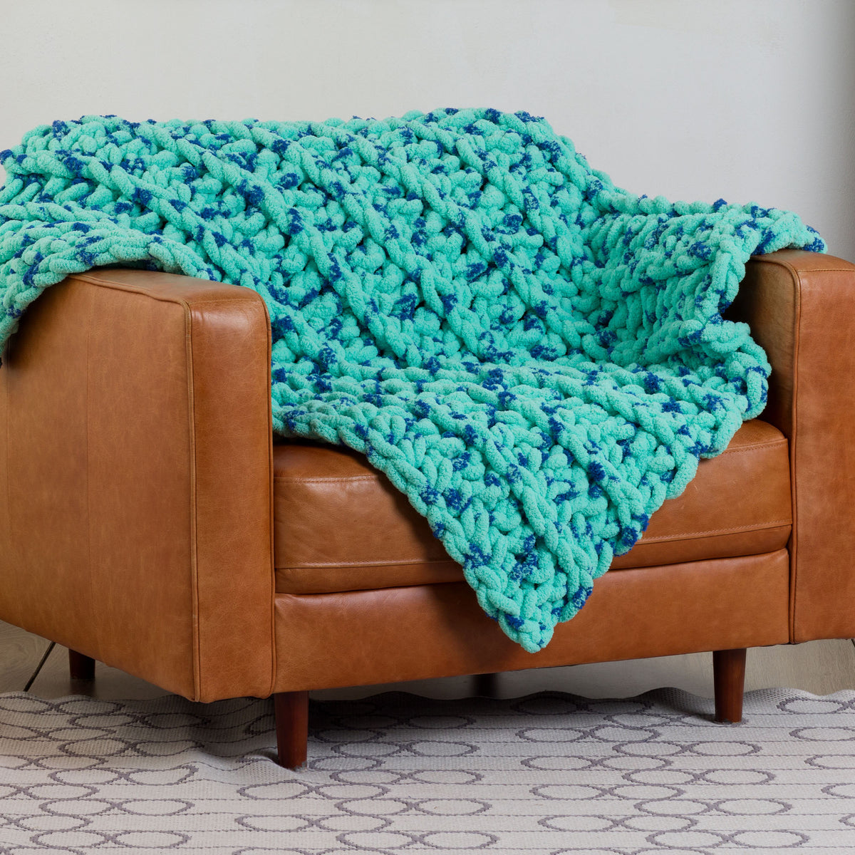 Ridged Big Crochet Blanket made using Bernat yarn in a styled lifestyle setting
