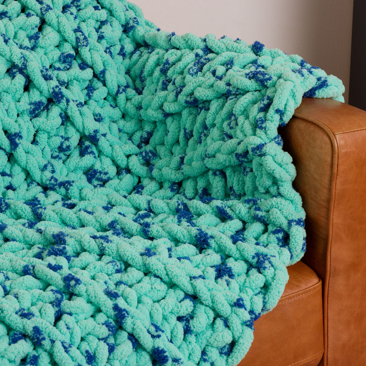 Ridged Big Crochet Blanket made using Bernat yarn in a styled lifestyle setting