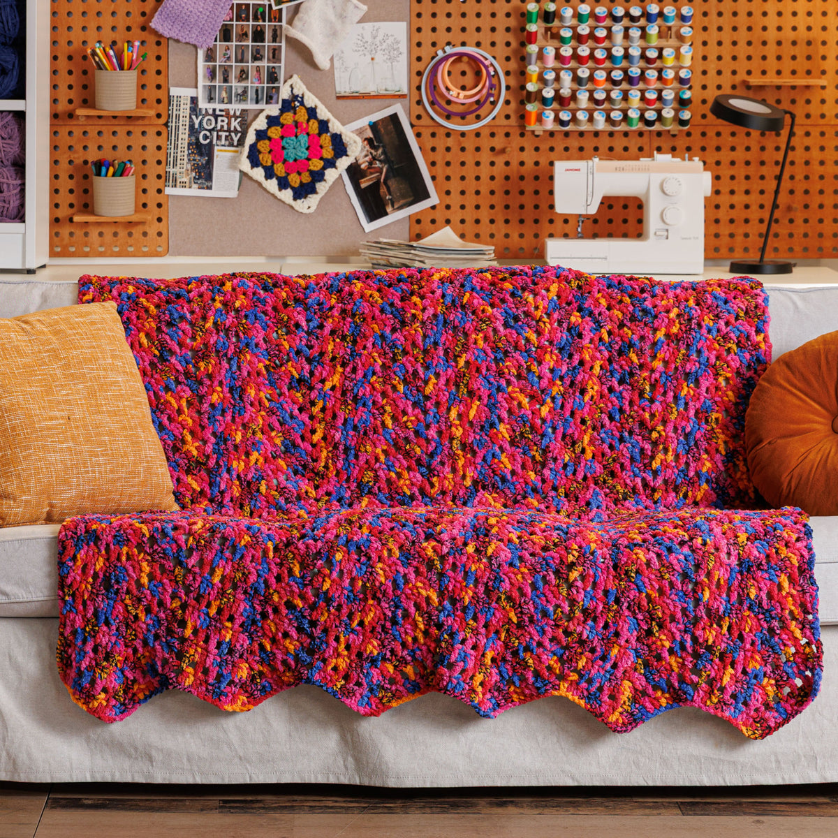 Candy Crochet Chevron Blanket made using Bernat yarn in a styled lifestyle setting