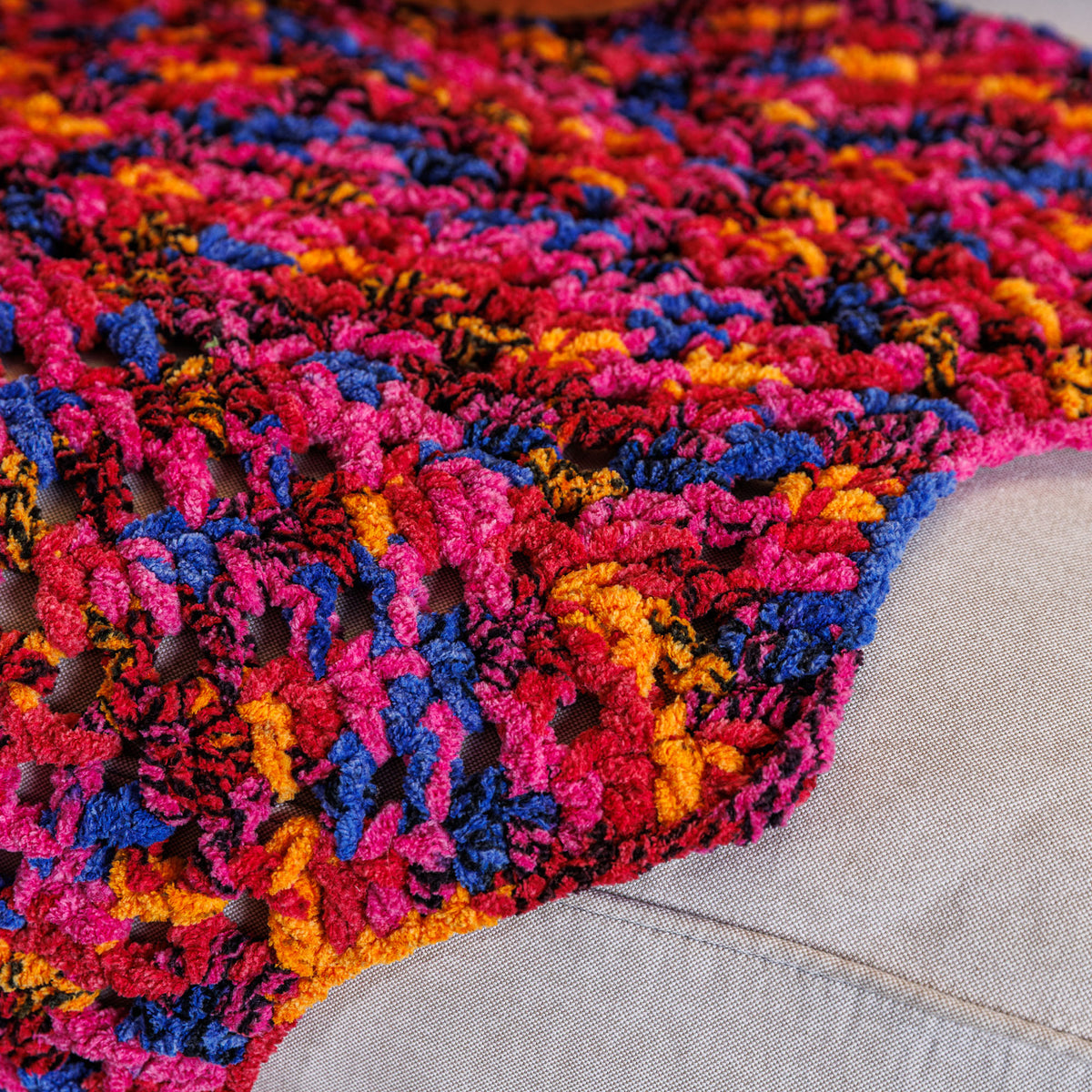Candy Crochet Chevron Blanket made using Bernat yarn in a styled lifestyle setting