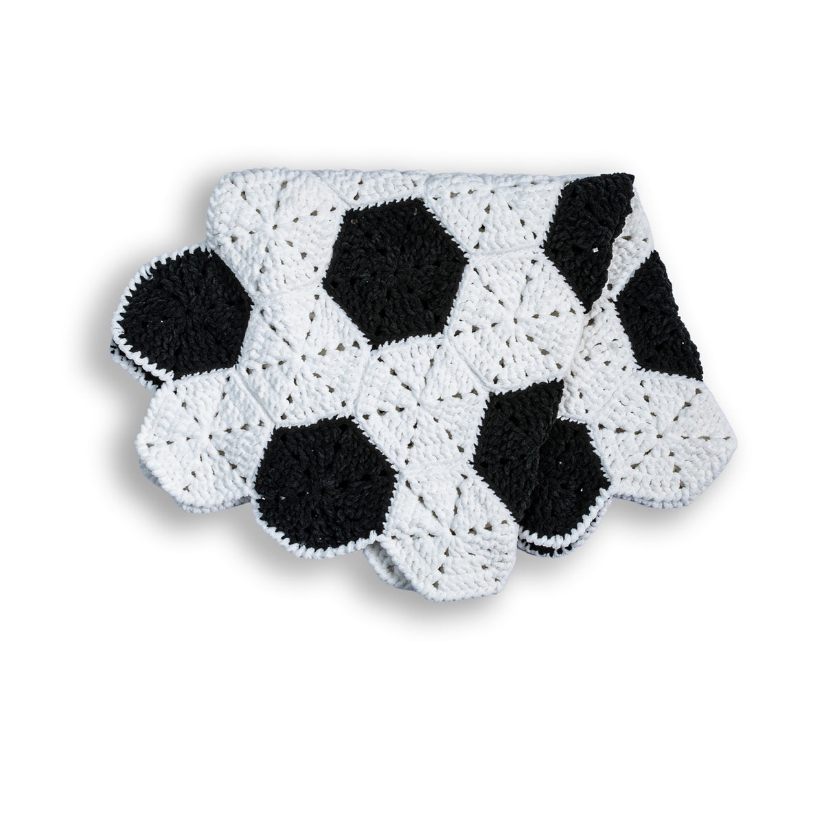 Crochet Soccer Ball Blanket made using Bernat yarn in a styled lifestyle setting