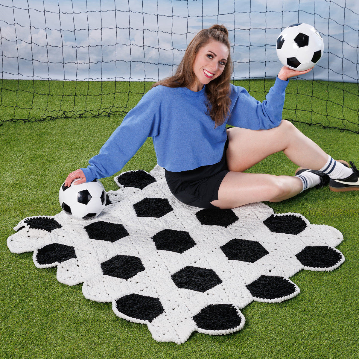 Crochet Soccer Ball Blanket made using Bernat yarn in a styled lifestyle setting