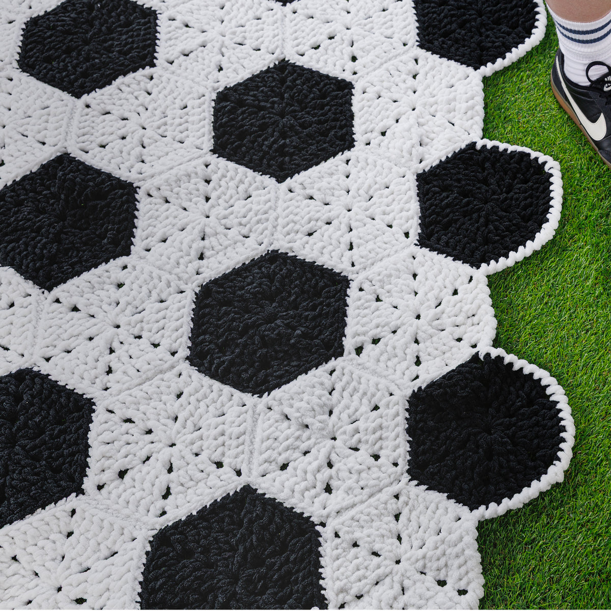 Crochet Soccer Ball Blanket made using Bernat yarn in a styled lifestyle setting