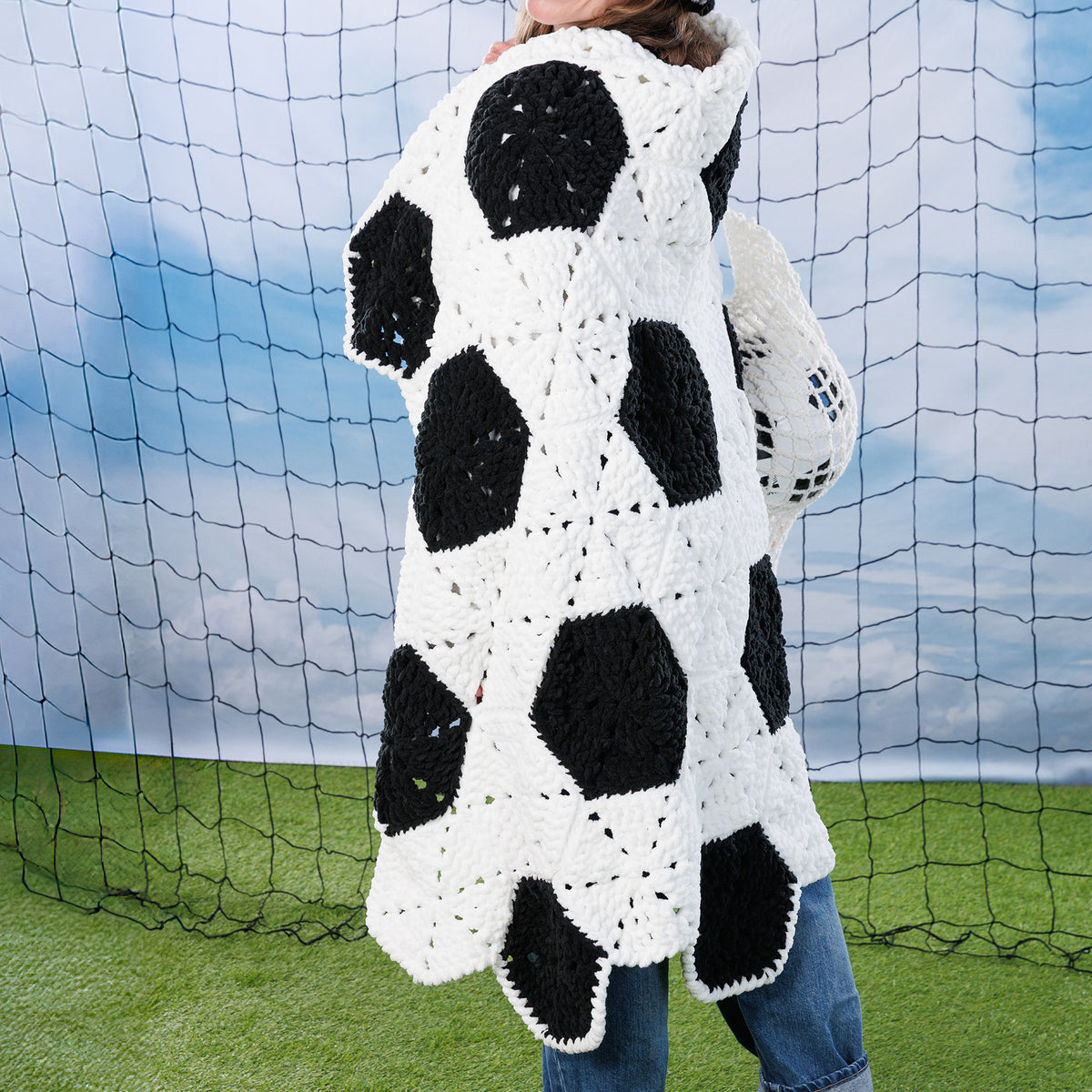 Crochet Soccer Ball Blanket made using Bernat yarn in a styled lifestyle setting