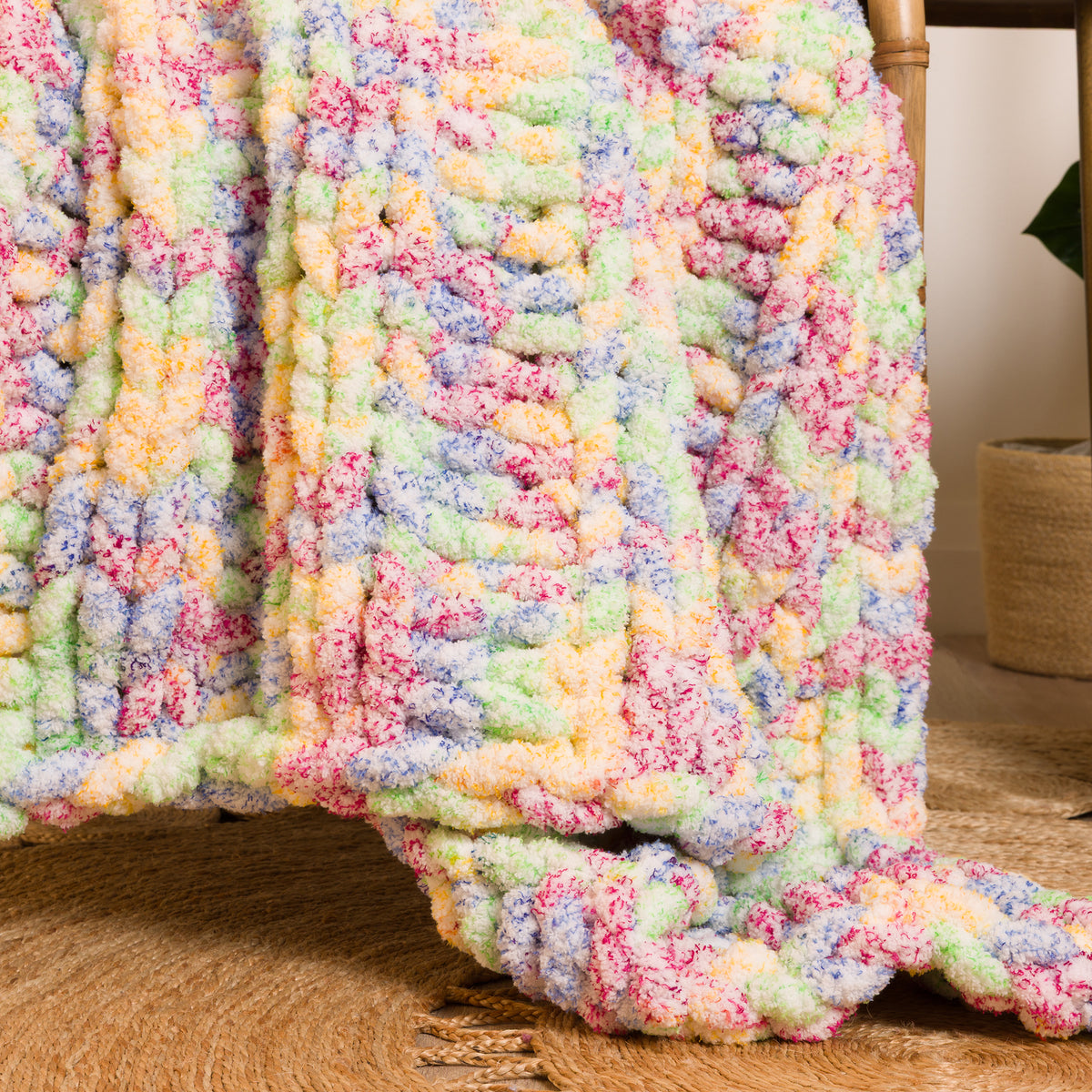 Simple Ribbing Table Knit Blanket made using Bernat yarn in a styled lifestyle setting