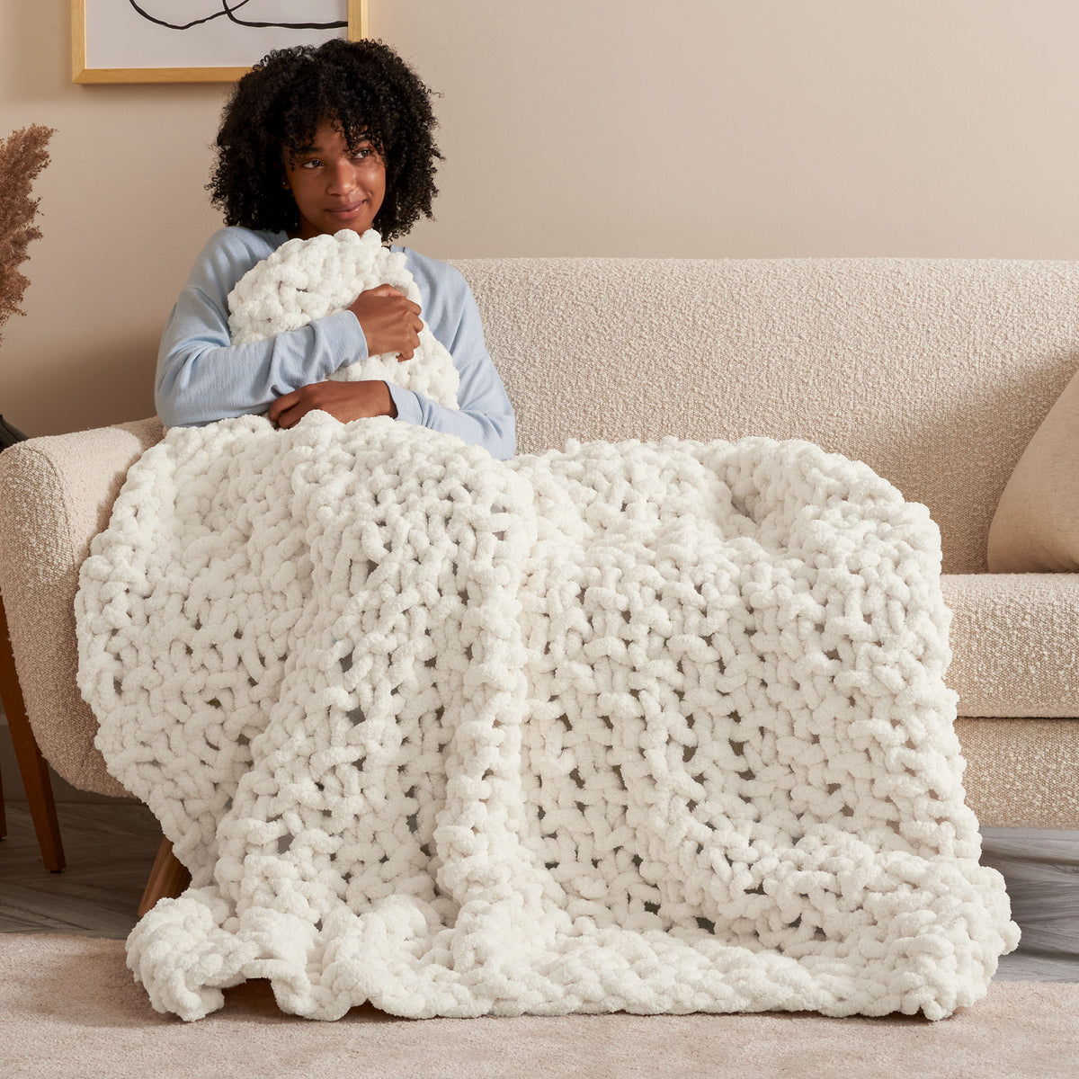 Cozy Does It Seed Stitch Knit Blanket made using Bernat yarn in a styled lifestyle setting