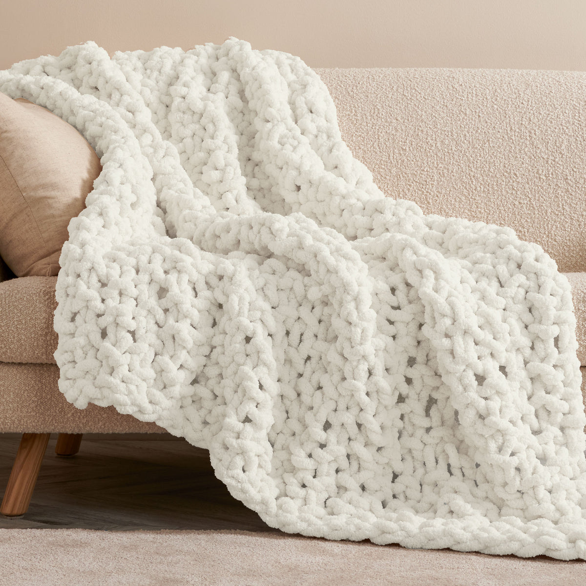 Cozy Does It Seed Stitch Knit Blanket made using Bernat yarn in a styled lifestyle setting