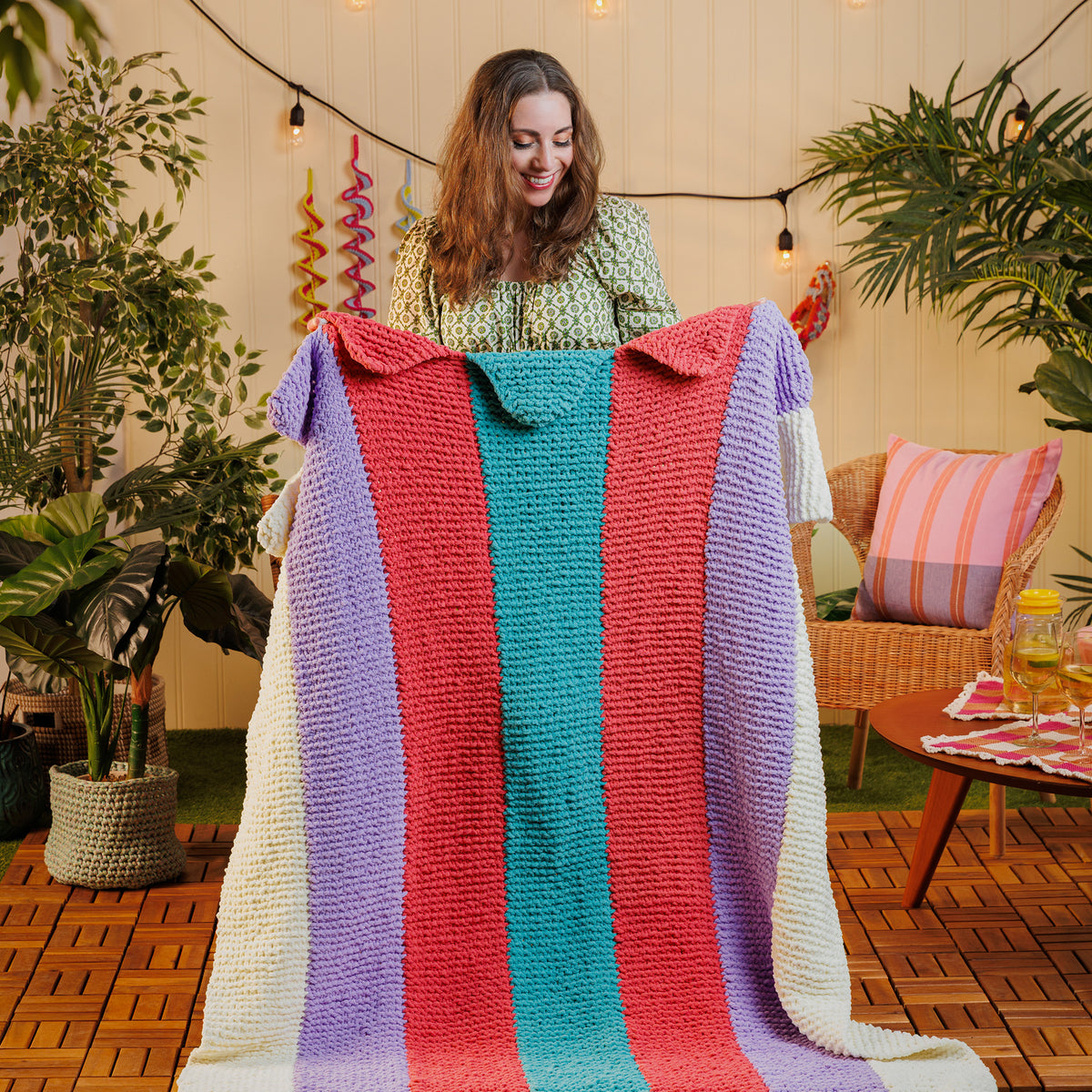 Knit Summer Scallops Blanket made using Bernat yarn in a styled lifestyle setting