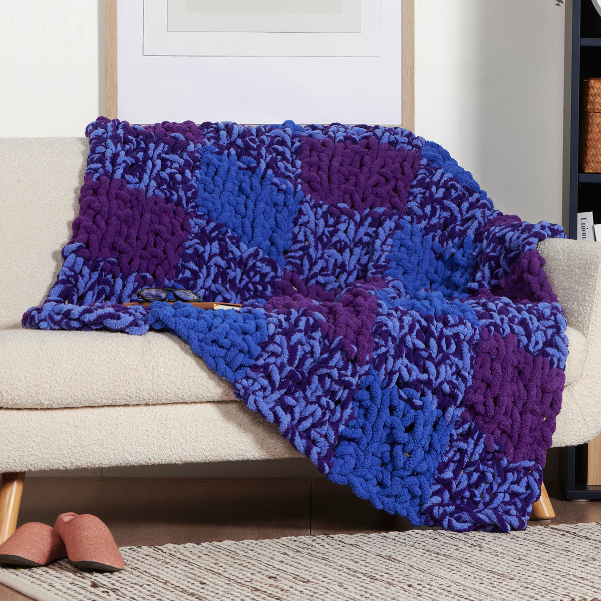 Just Plaid To Be Here Table Knit Blanket made using Bernat yarn in a styled lifestyle setting