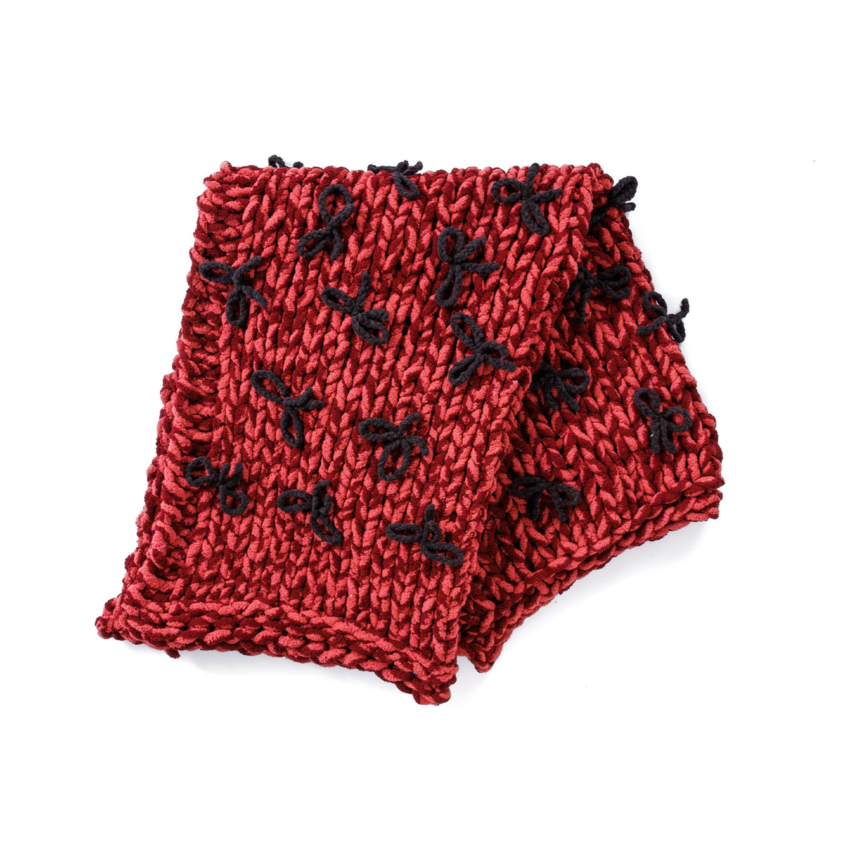 Put A Bow On It Table Knit Blanket made using Bernat yarn in a styled lifestyle setting