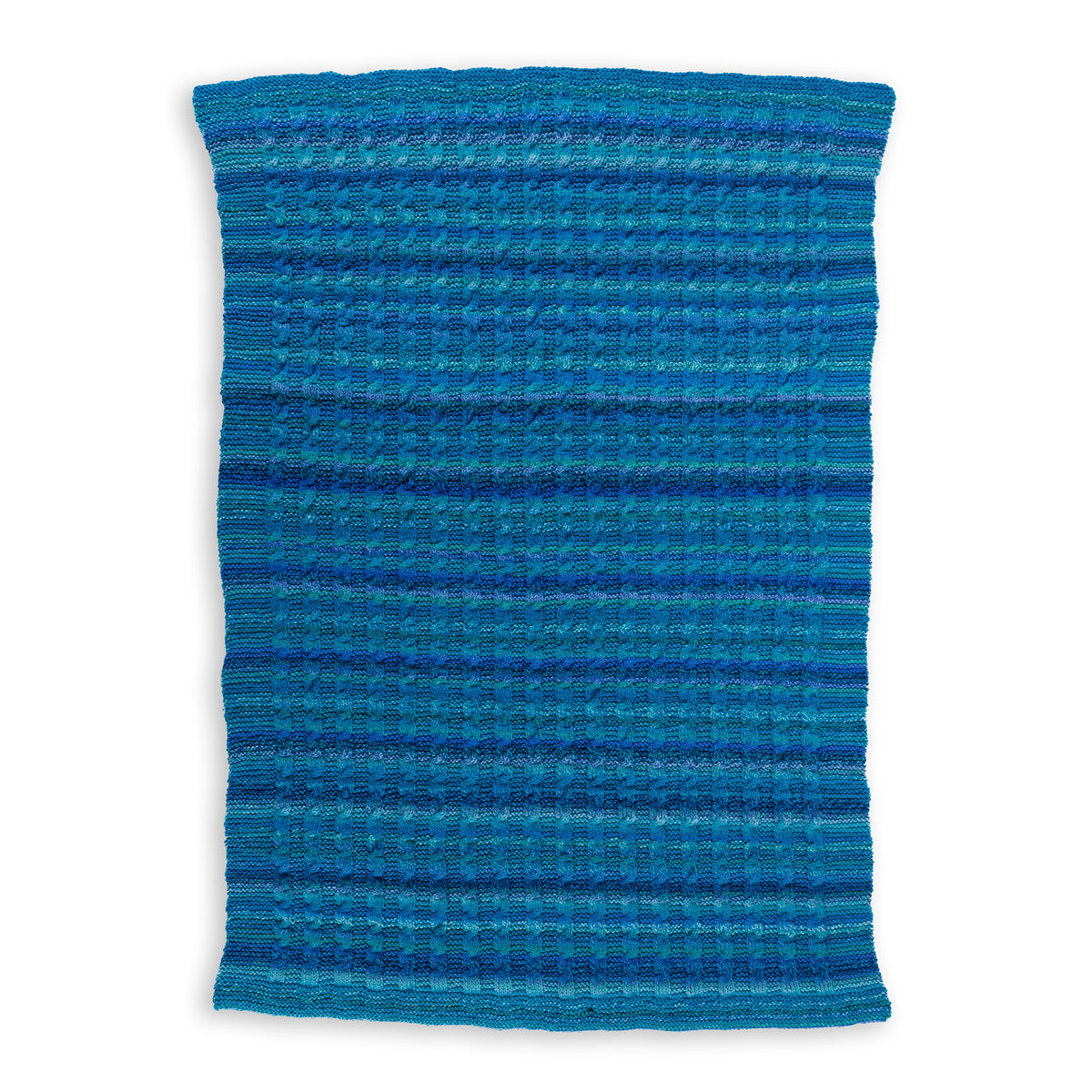 Knit Classic Cables Throw made using Bernat yarn on a white background