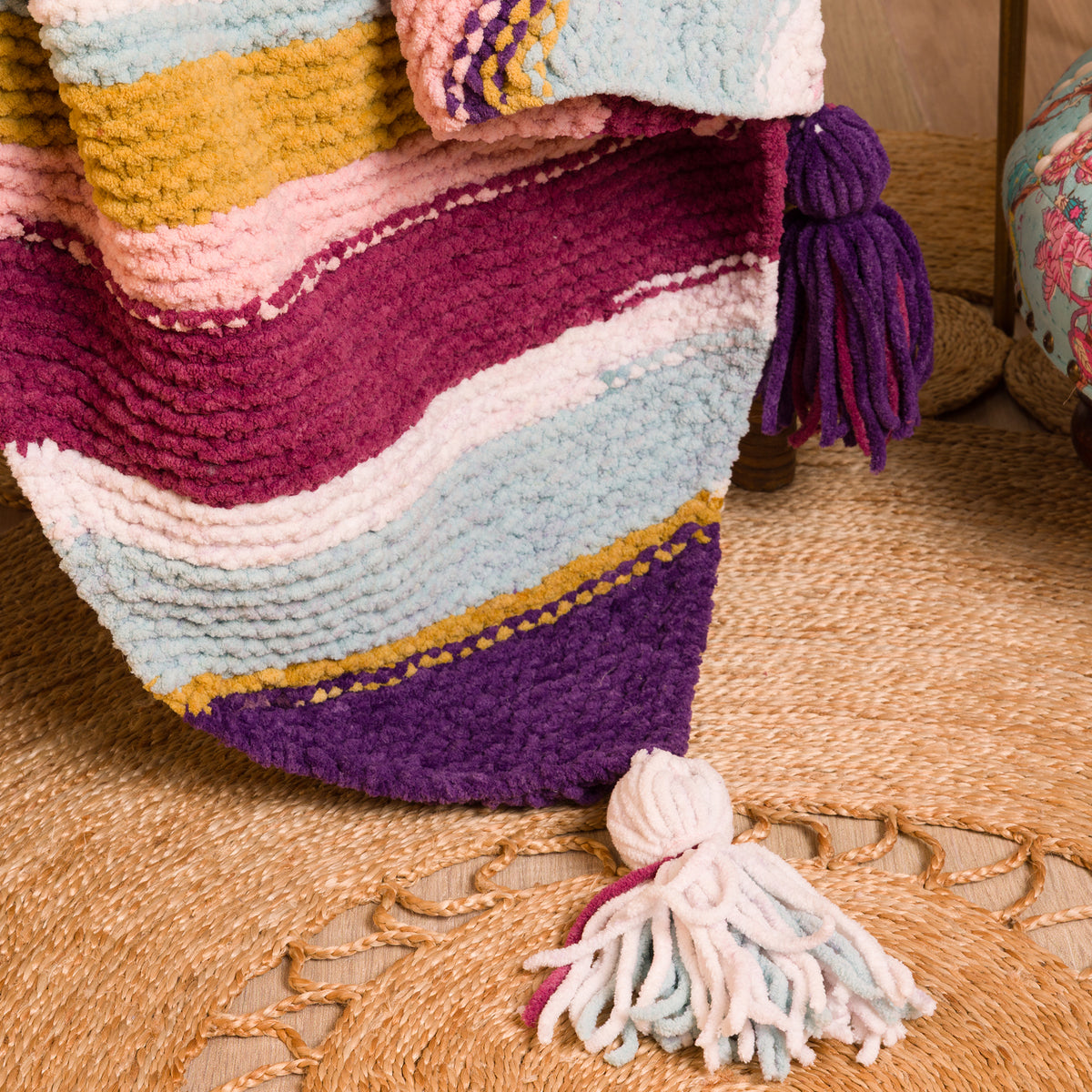 Quarter Stripes Knit Blanket made using Bernat yarn in a styled lifestyle setting