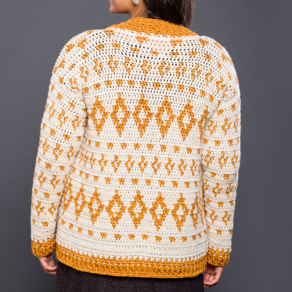 Diamond Dancer Crochet Cardigan made using Caron yarn in a styled lifestyle setting