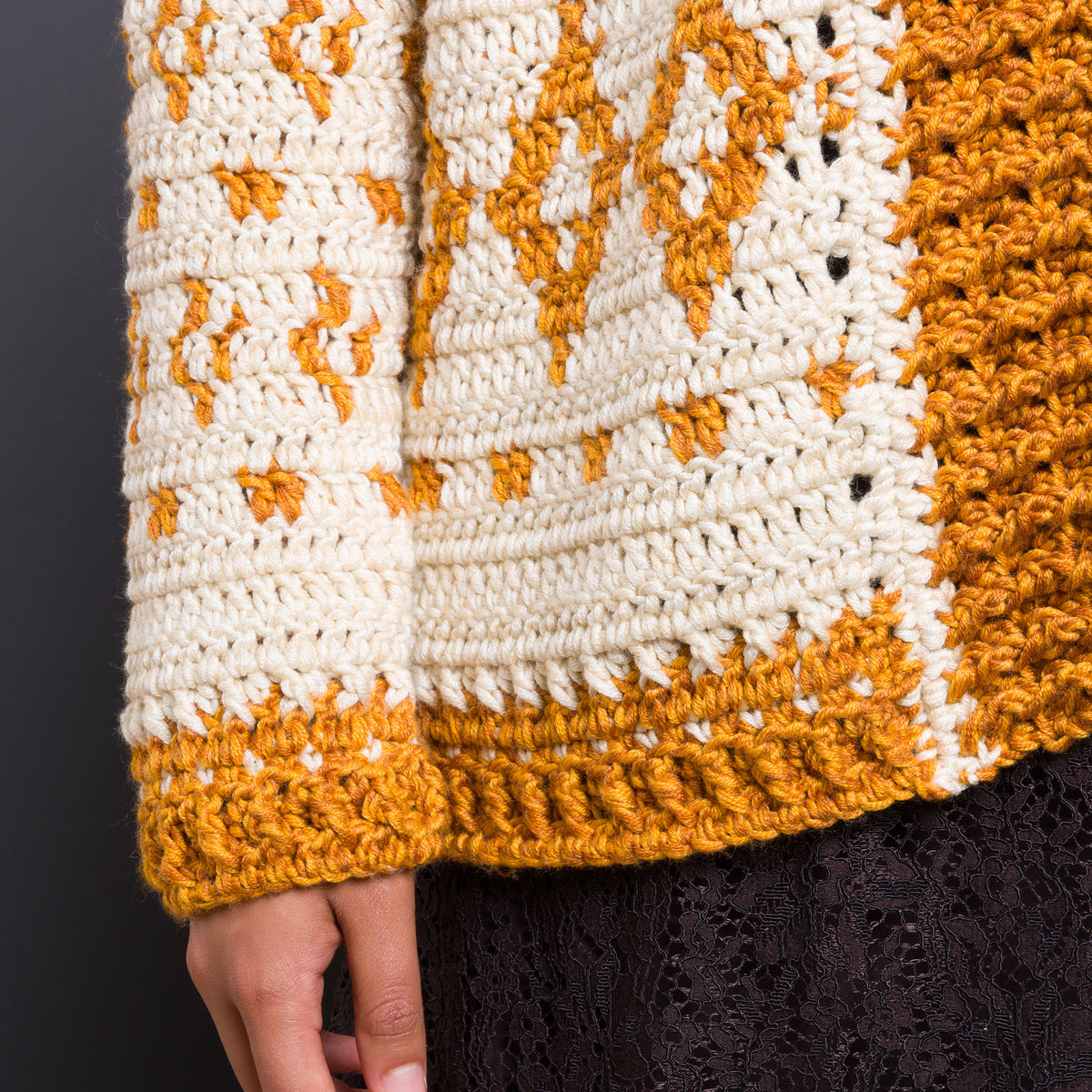 Diamond Dancer Crochet Cardigan made using Caron yarn in a styled lifestyle setting