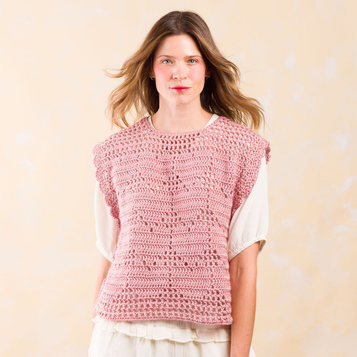 Crochet Filet Heart Vest made using Caron yarn in a styled lifestyle setting