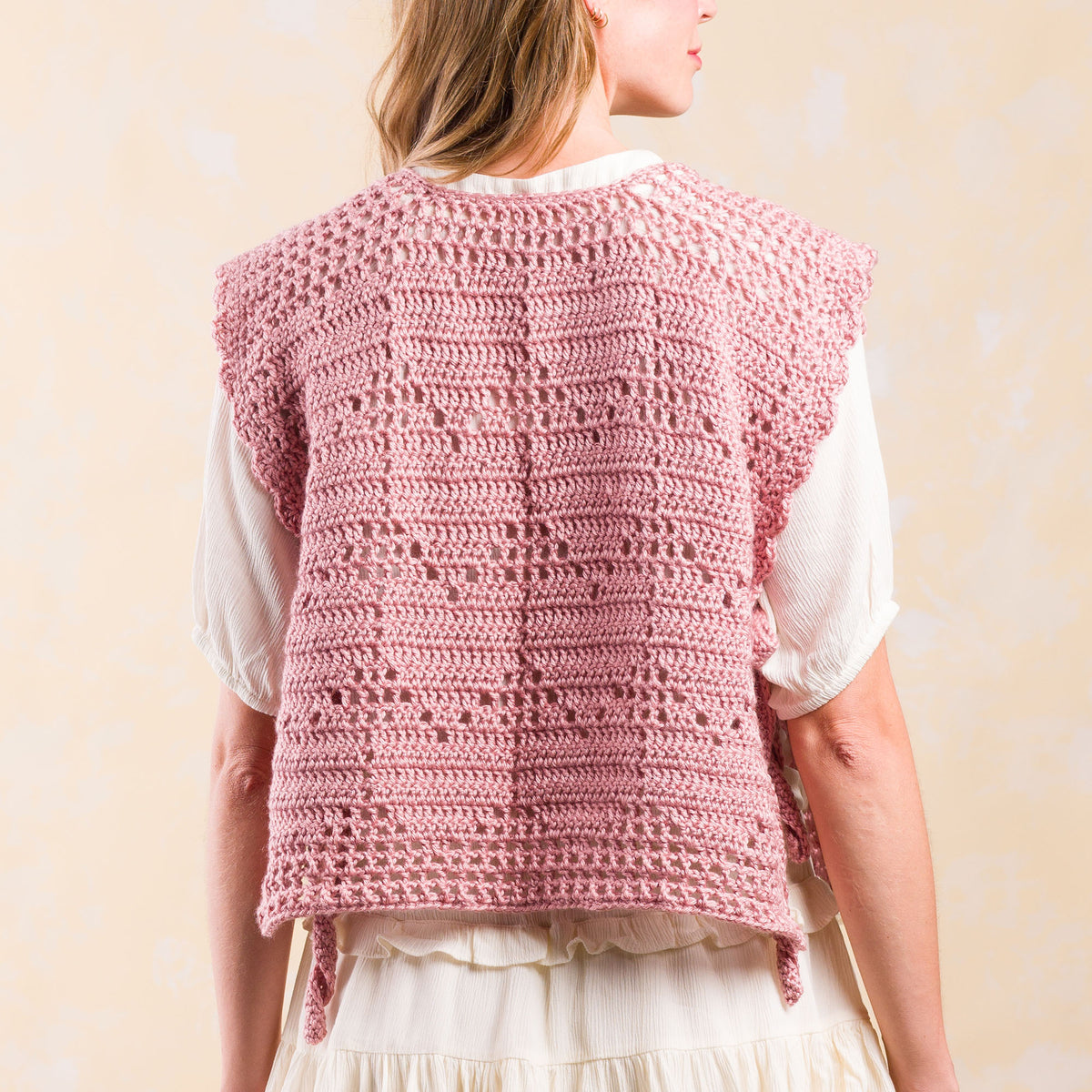 Crochet Filet Heart Vest made using Caron yarn in a styled lifestyle setting