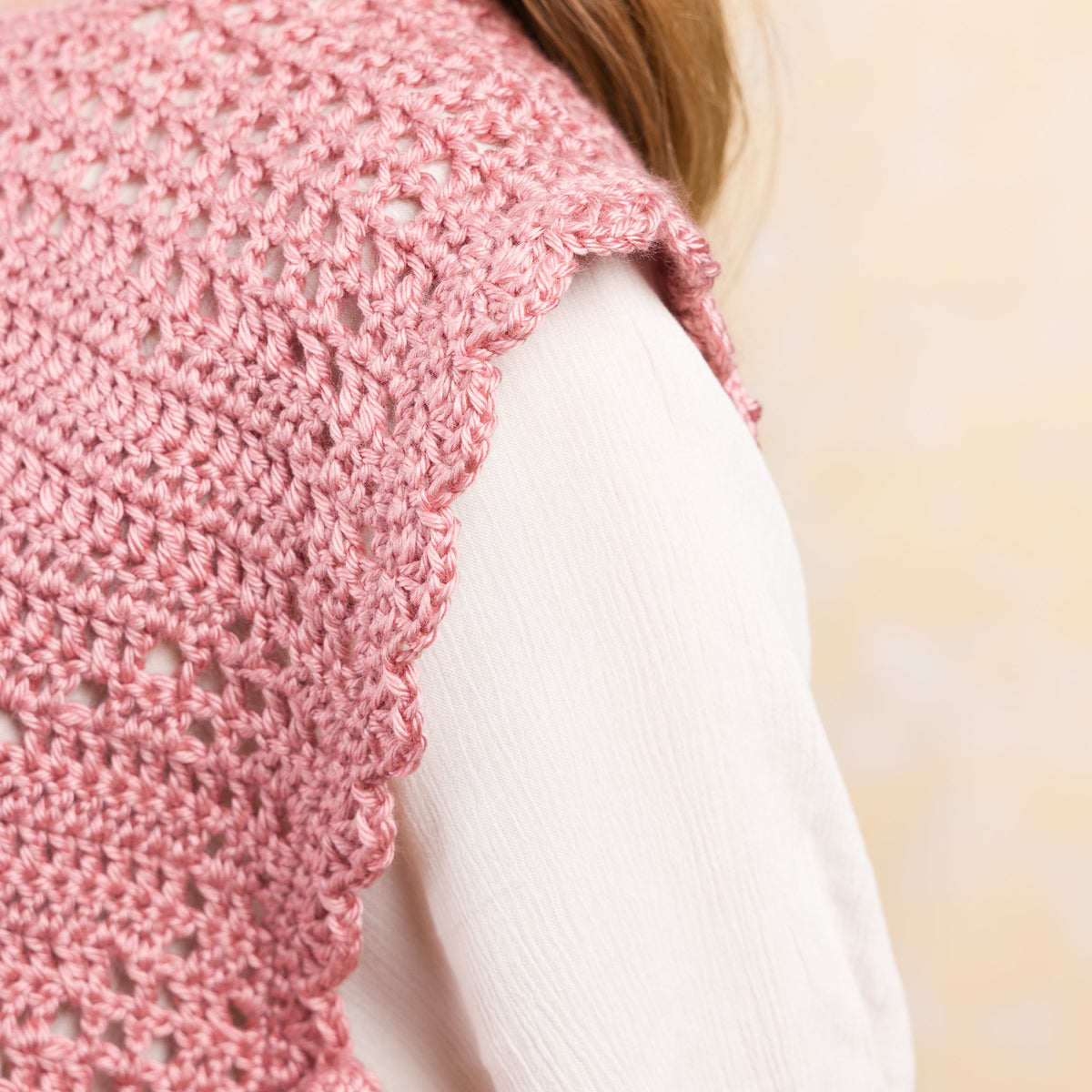 Crochet Filet Heart Vest made using Caron yarn in a styled lifestyle setting