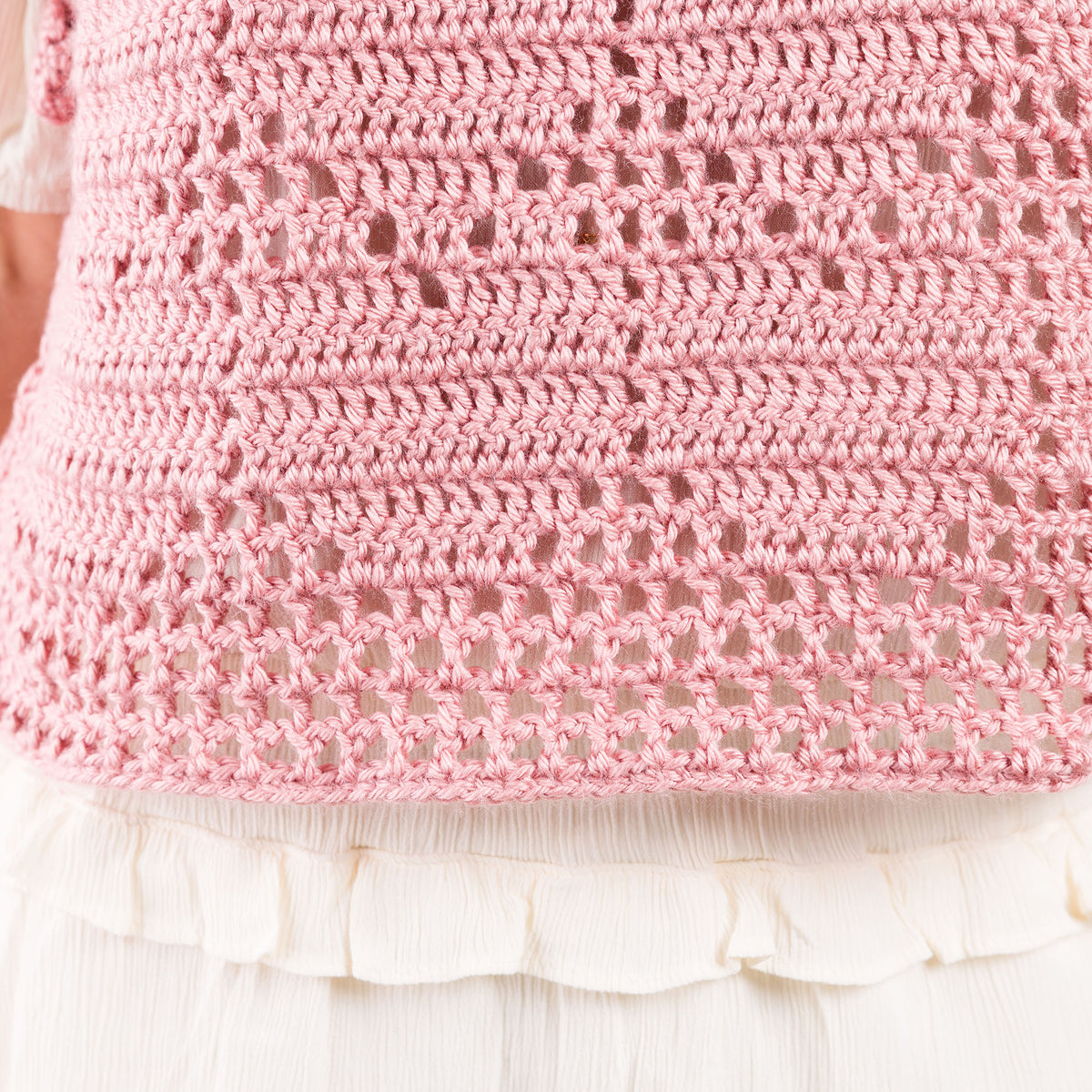 Crochet Filet Heart Vest made using Caron yarn in a styled lifestyle setting