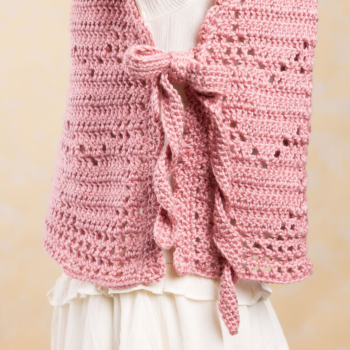 Crochet Filet Heart Vest made using Caron yarn in a styled lifestyle setting