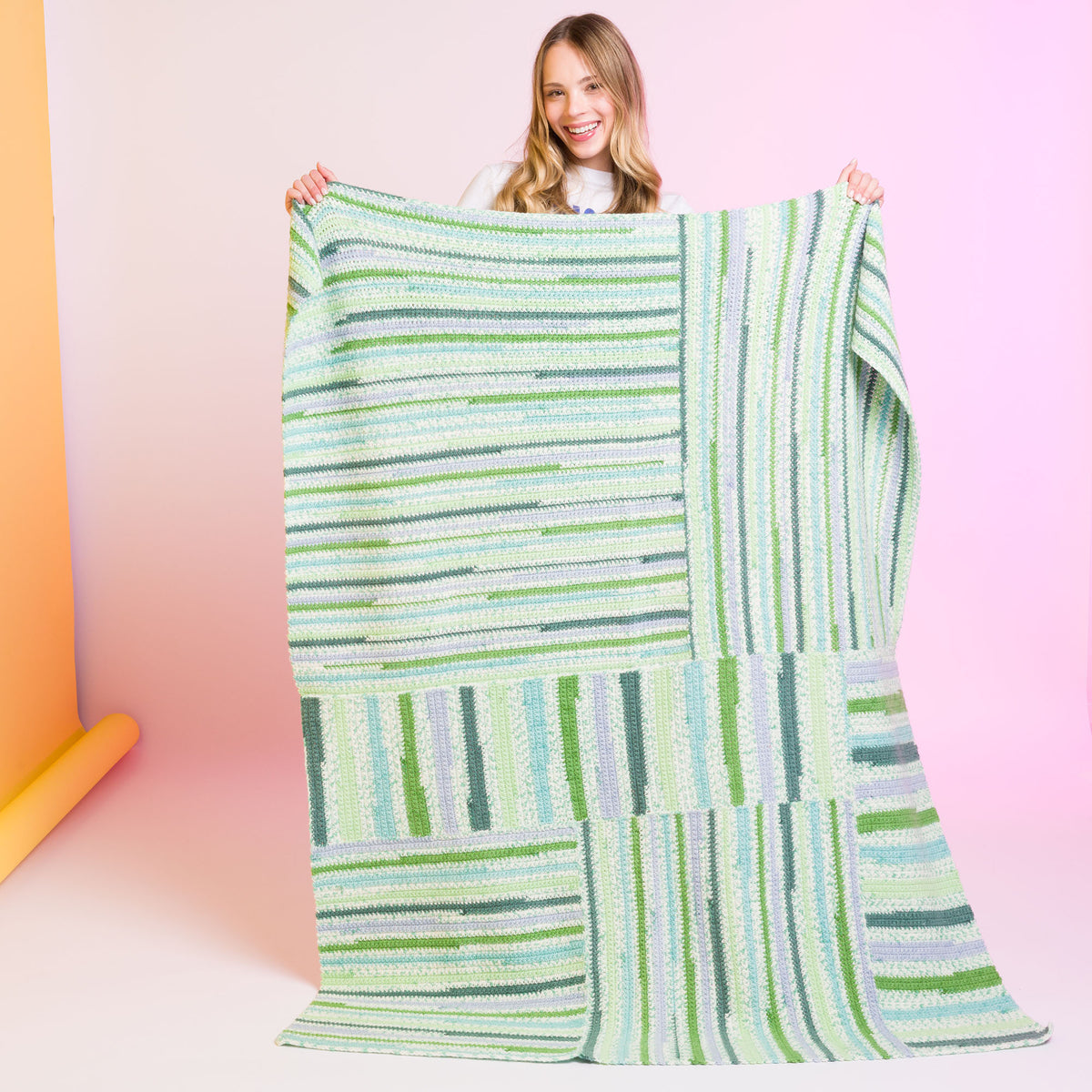 Crochet Every Way Blanket made using Caron yarn in a styled lifestyle setting