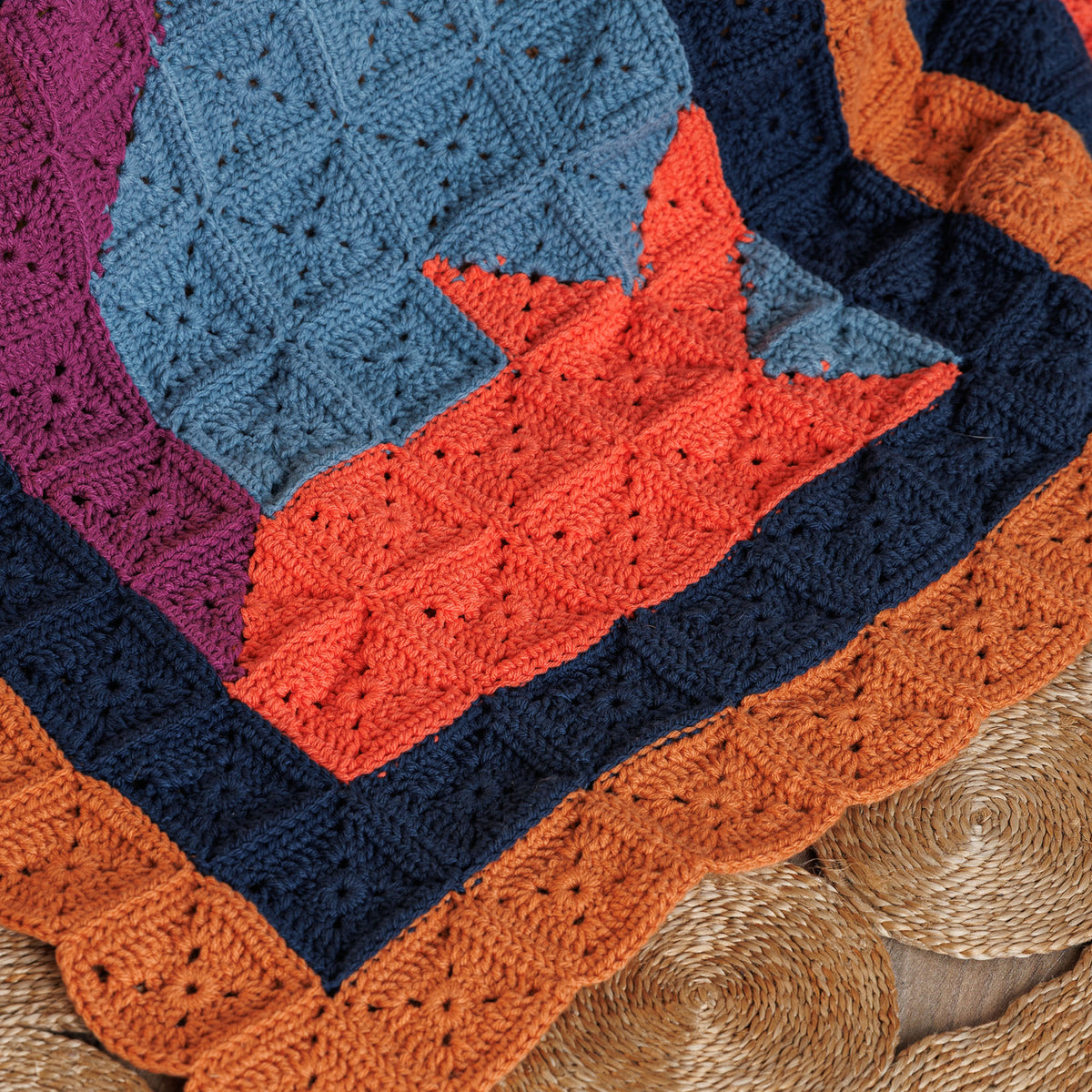 Crochet Feline Framework Quilt made using Caron yarn in a styled lifestyle setting