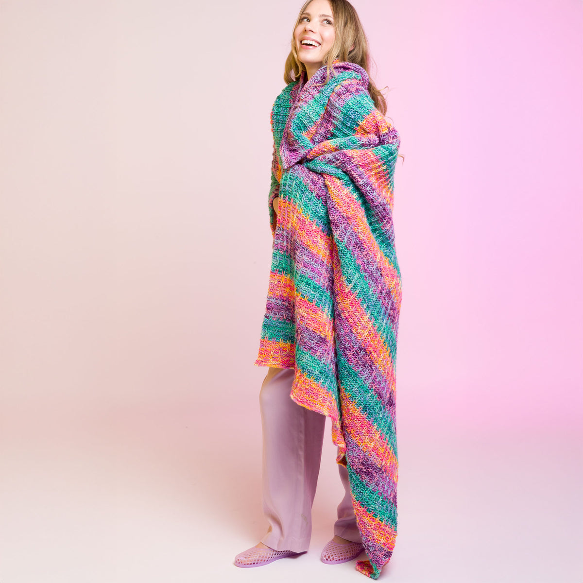 Slipstream Knit Blanket made using Caron yarn in a styled lifestyle setting