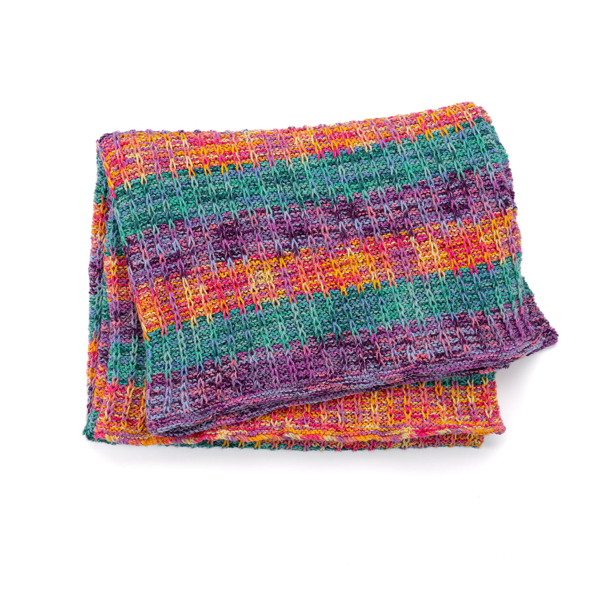 Slipstream Knit Blanket made using Caron yarn in a styled lifestyle setting