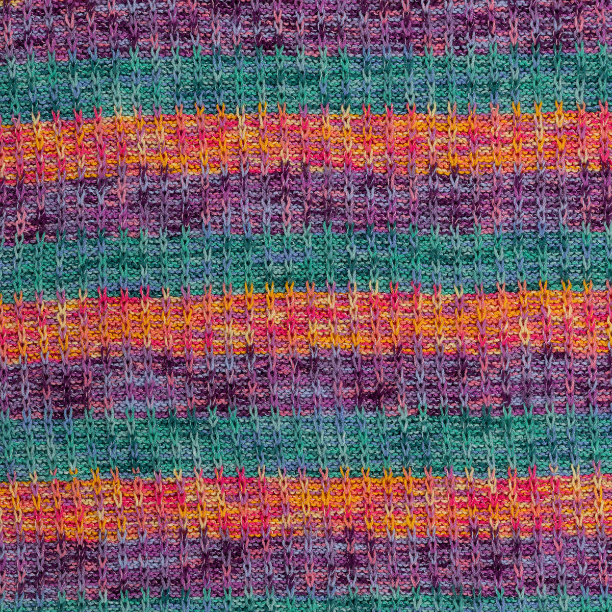 Slipstream Knit Blanket made using Caron yarn in a styled lifestyle setting