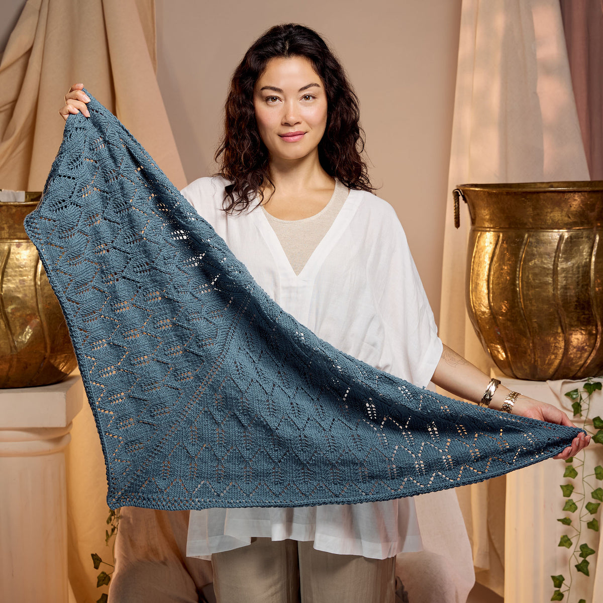 Ocean Waves Knit Shawl made using Caron yarn in a styled lifestyle setting