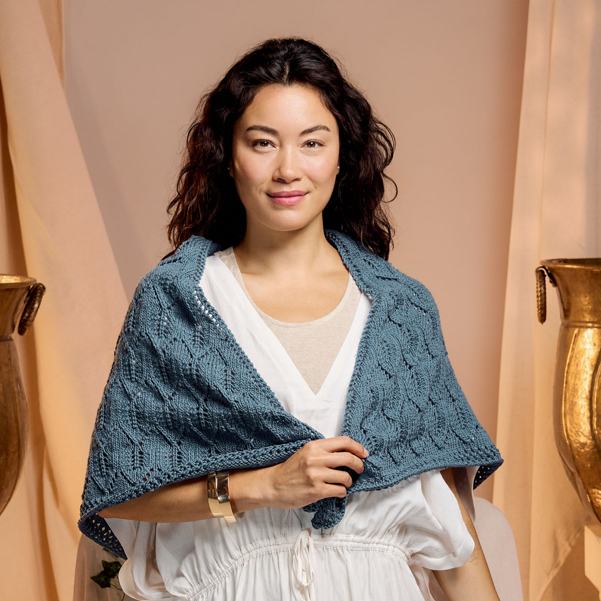 Ocean Waves Knit Shawl made using Caron yarn in a styled lifestyle setting