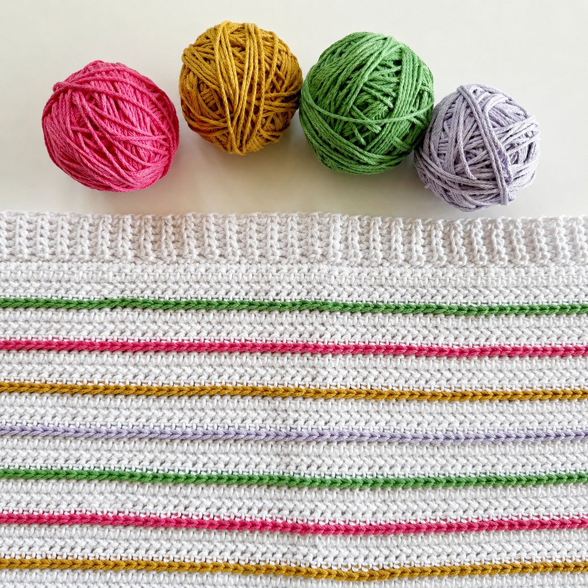 Bloom Stipes Blanket made using Cotton yarn in a styled lifestyle setting