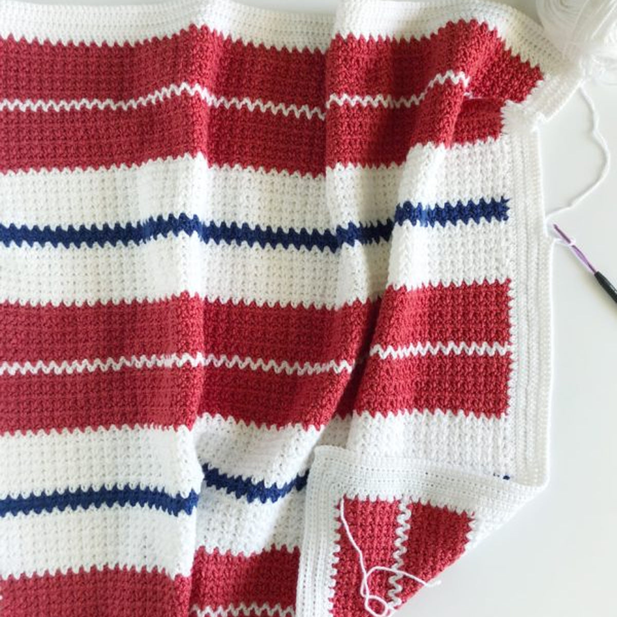 Americana V-Stitch Crochet Blanket made using Modern yarn in a styled lifestyle setting