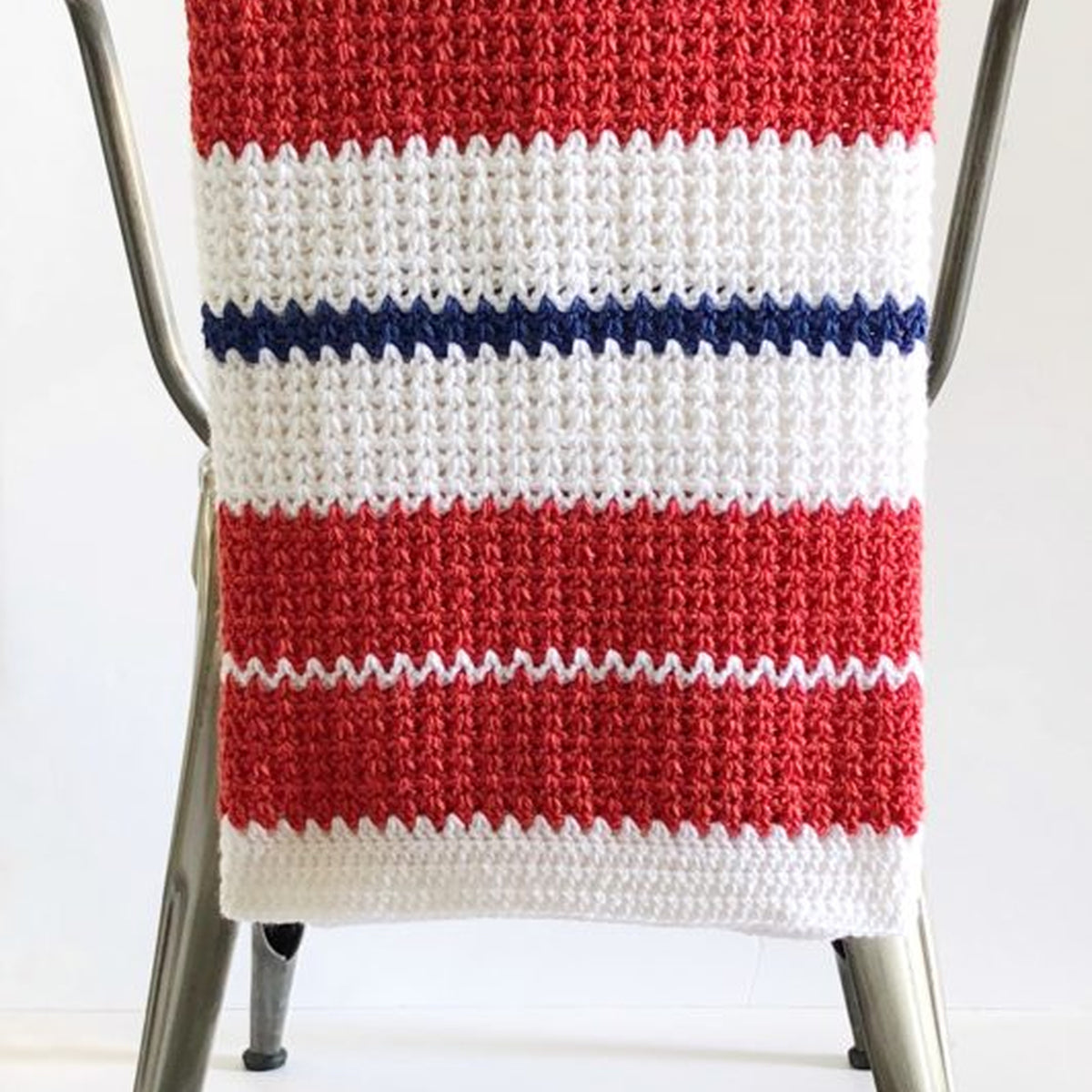 Americana V-Stitch Crochet Blanket made using Modern yarn on a white background
