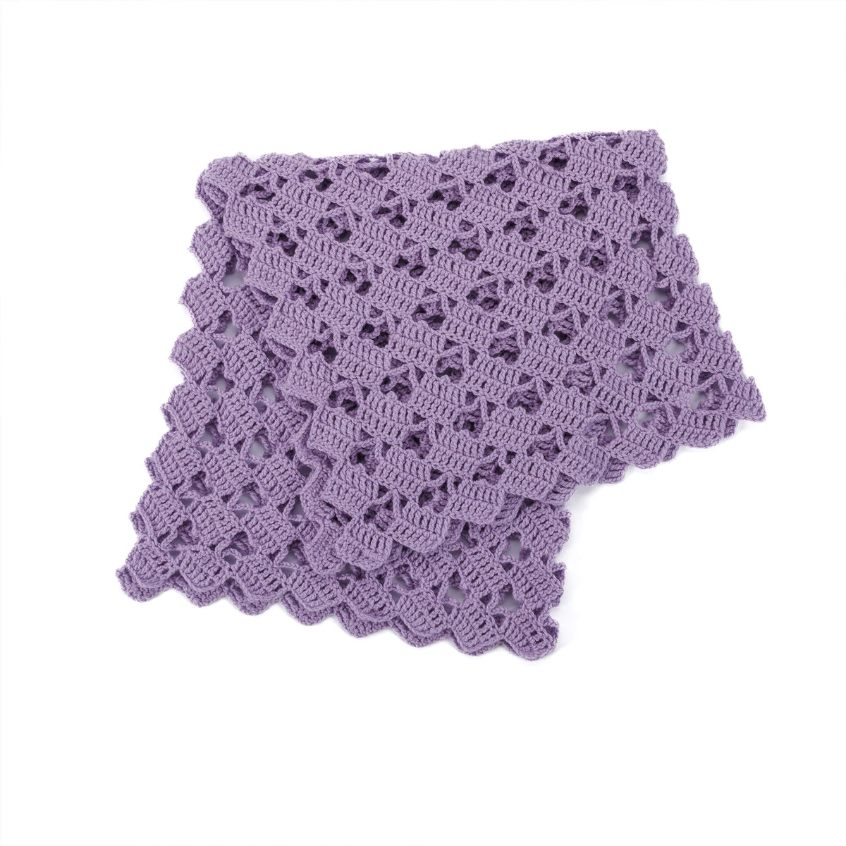 Crochet Heart-Y Lace Blanket made using Red Heart yarn in a styled lifestyle setting