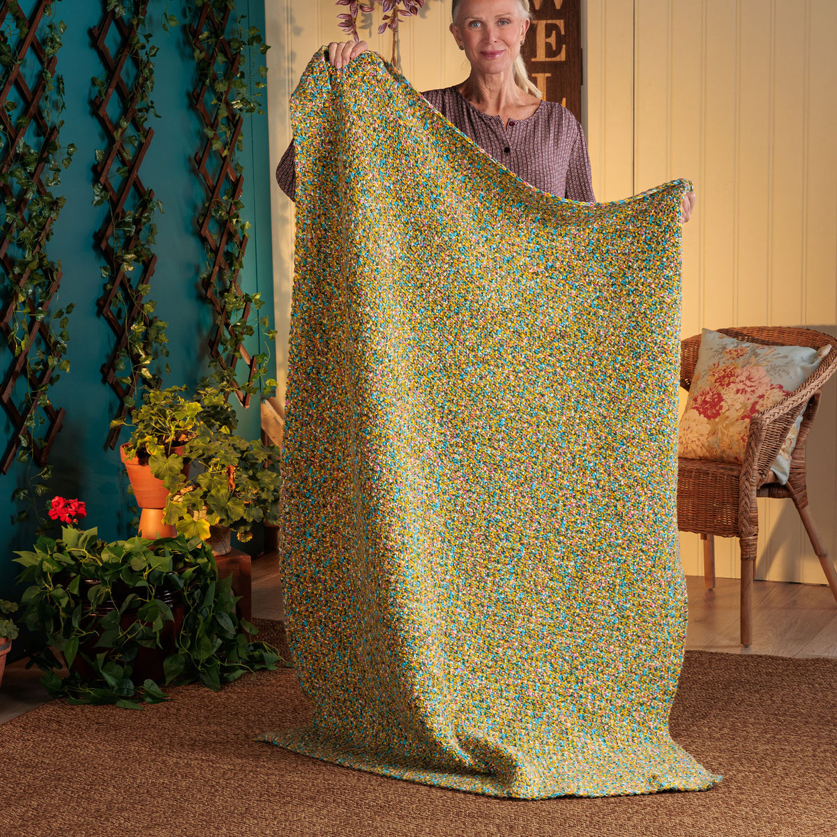 Flowing Texture Crochet Blanket made using Red Heart yarn in a styled lifestyle setting