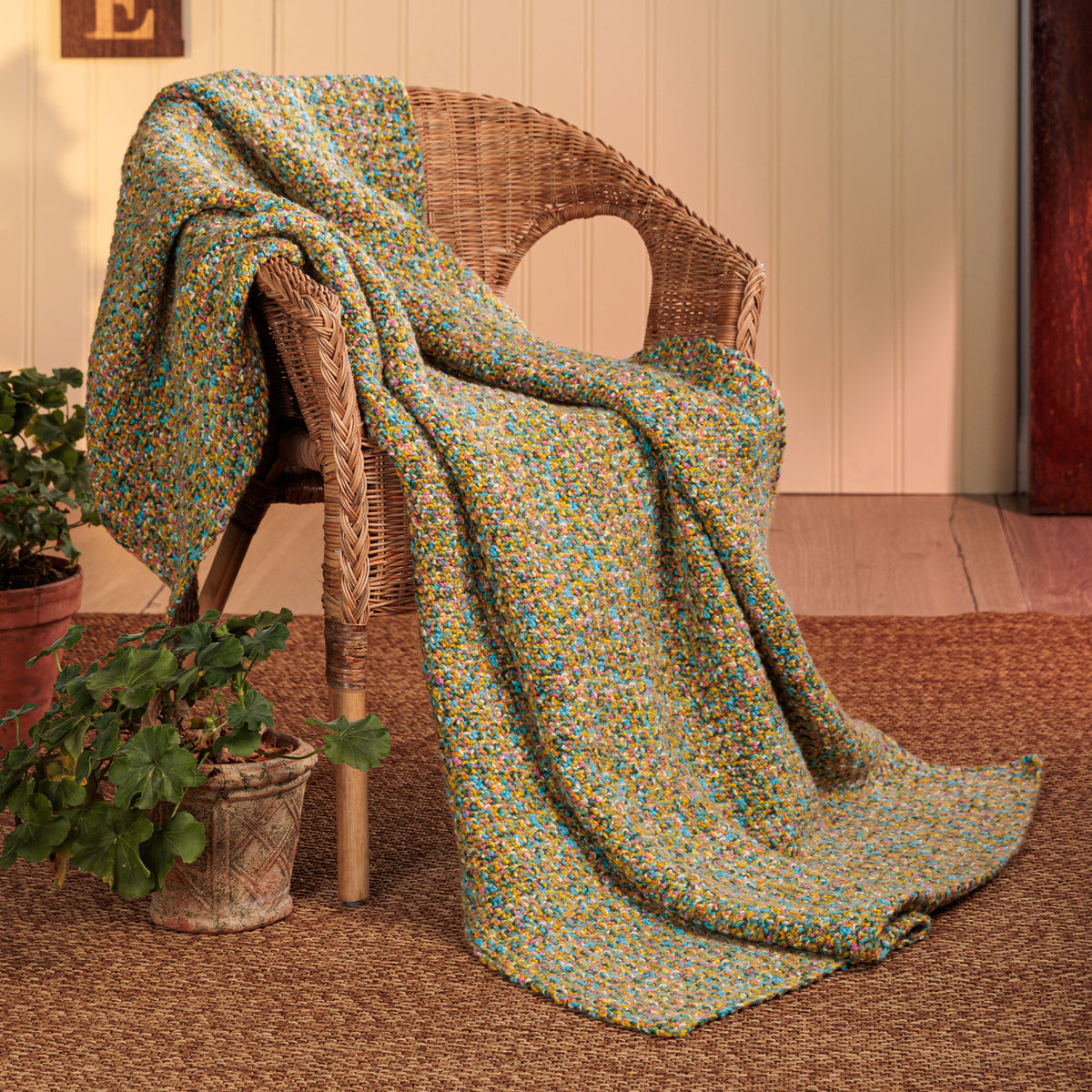 Flowing Texture Crochet Blanket made using Red Heart yarn in a styled lifestyle setting