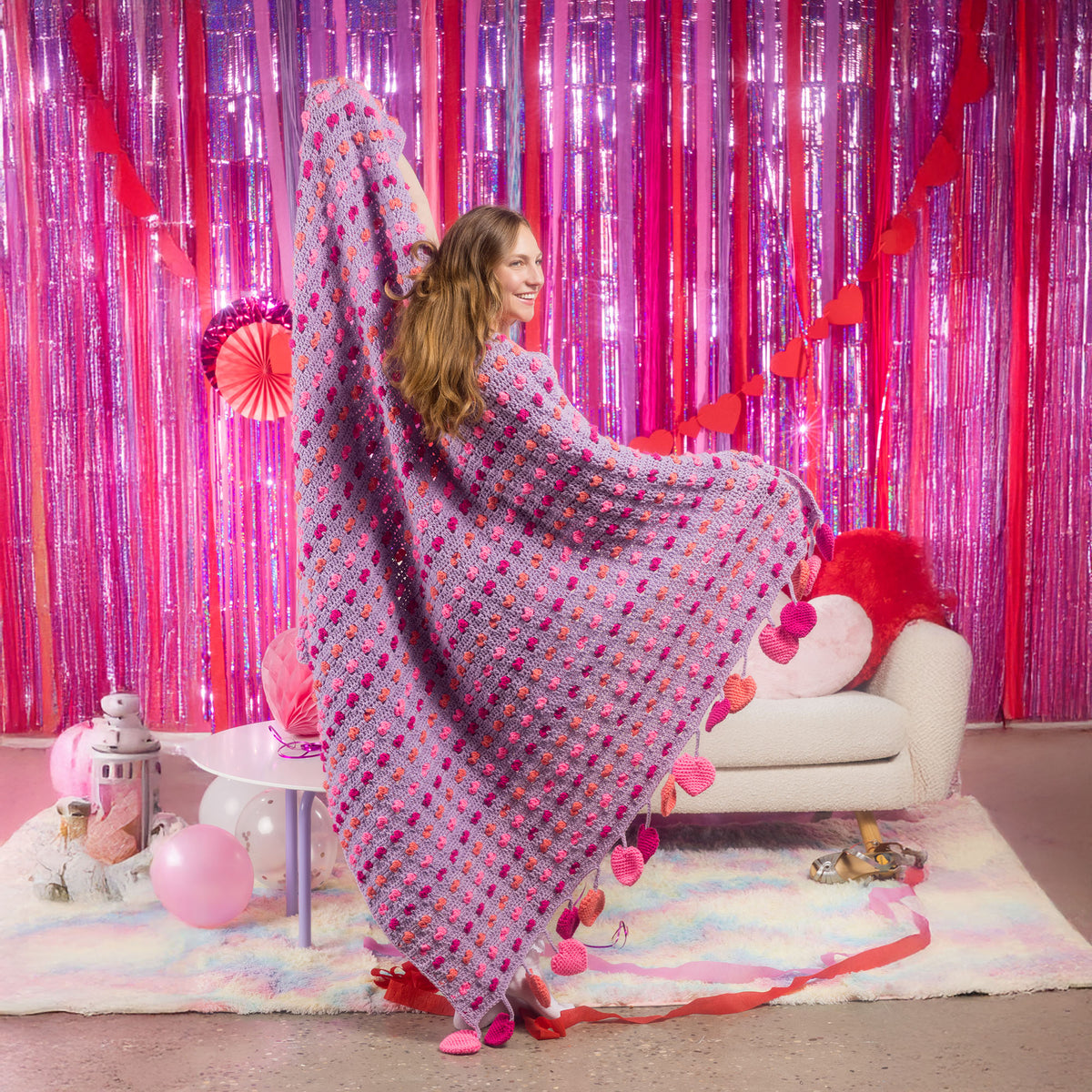 Love Crochet Blanket made using Red Heart yarn in a styled lifestyle setting