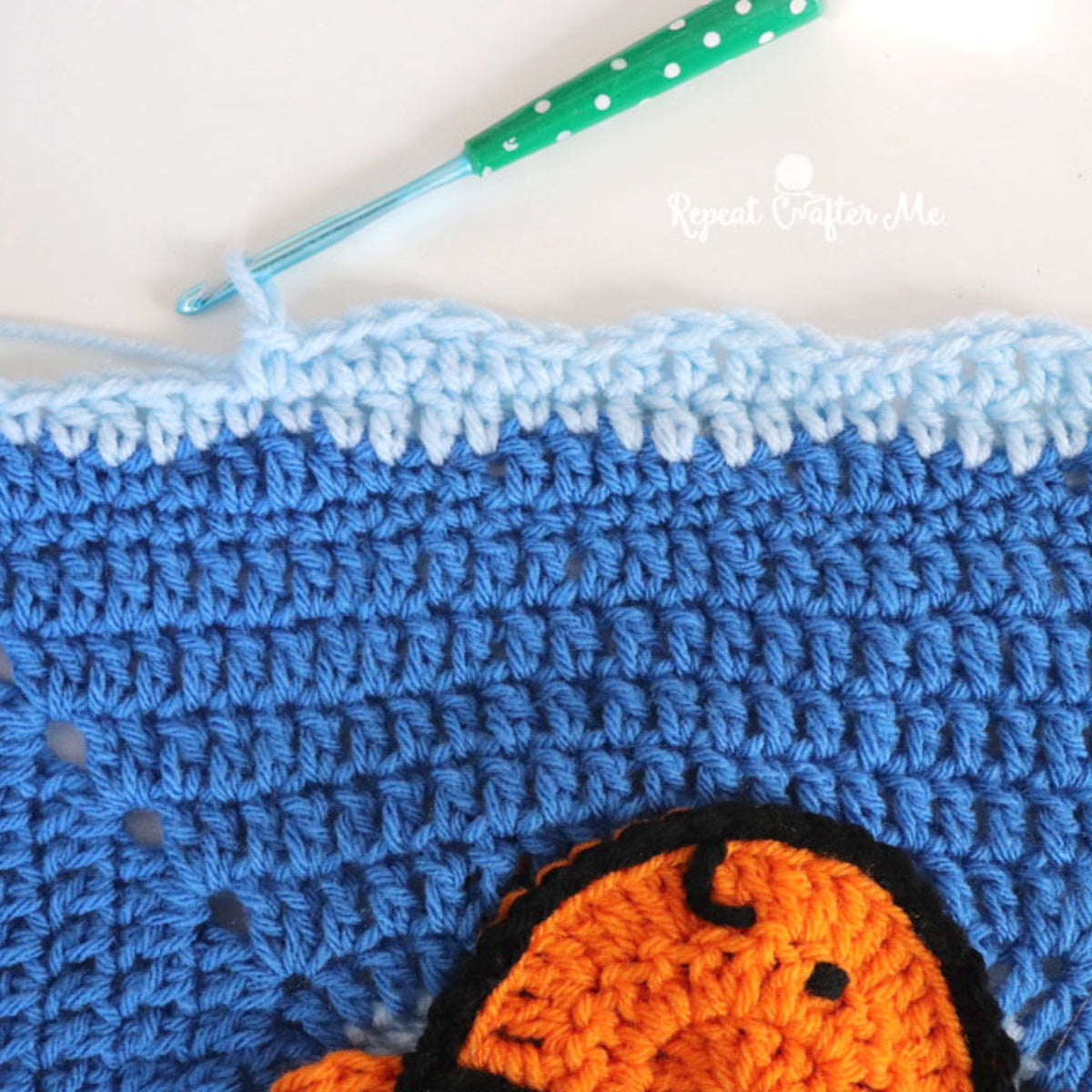 Under The Sea Crochet Blanket made using Red Heart yarn in a styled lifestyle setting