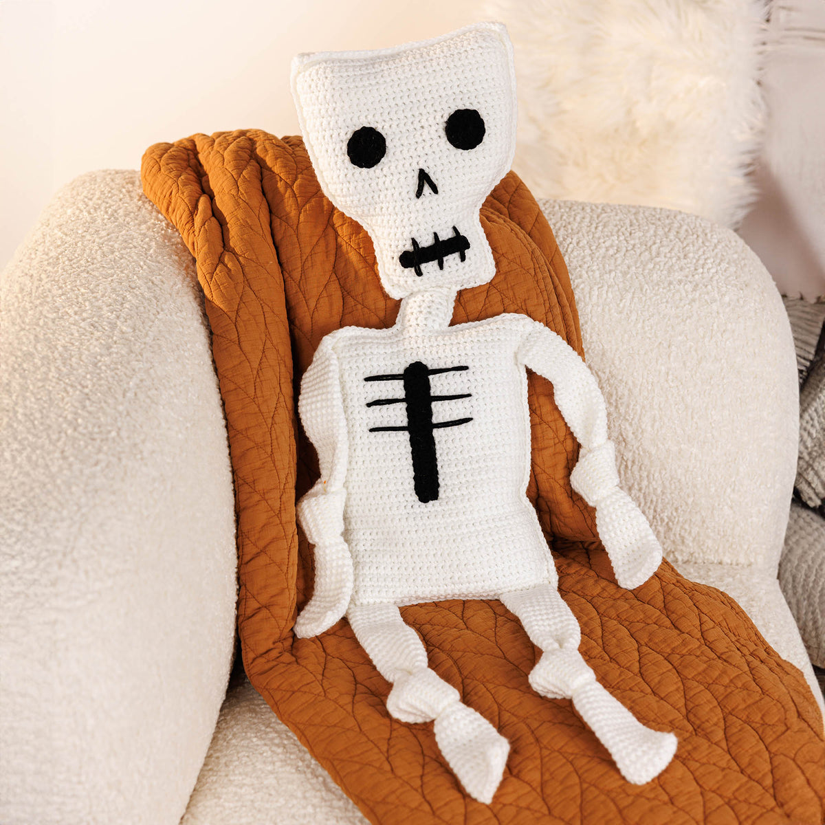 Crochet Mr. Bones Skeleton Pillow made using Red Heart yarn