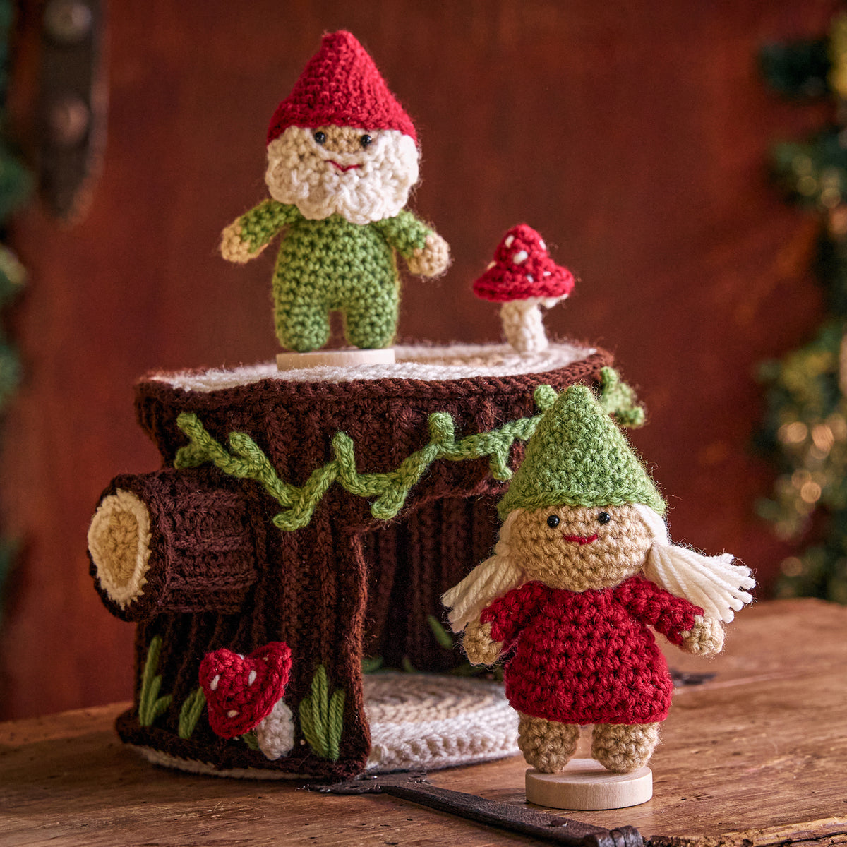 Crochet Gnomes With A Little Stump House made using Red Heart yarn in a styled lifestyle setting
