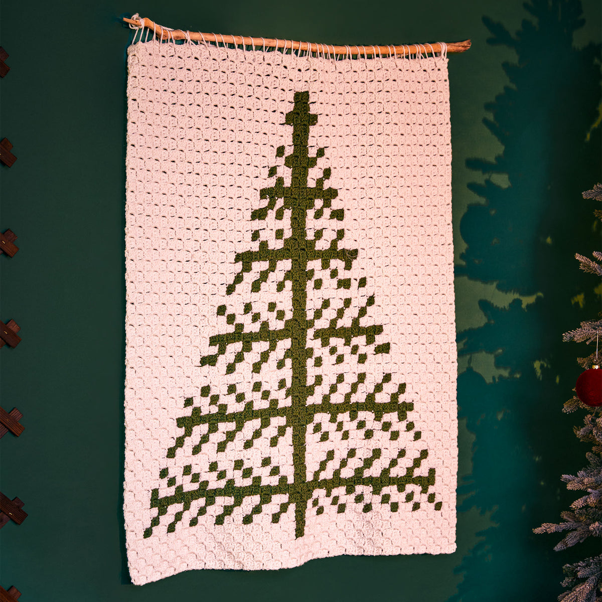 Graphic Tree Crochet Wall Hanging made using Red Heart yarn in a styled lifestyle setting
