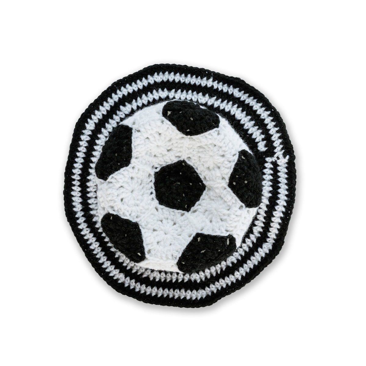 Crochet Soccer Ball Hat made using Red Heart yarn in a styled lifestyle setting