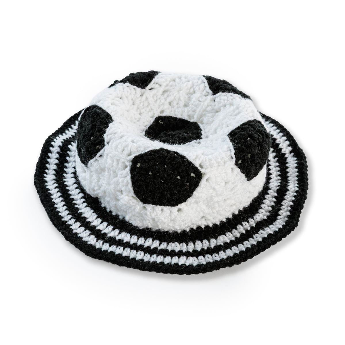 Crochet Soccer Ball Hat made using Red Heart yarn in a styled lifestyle setting