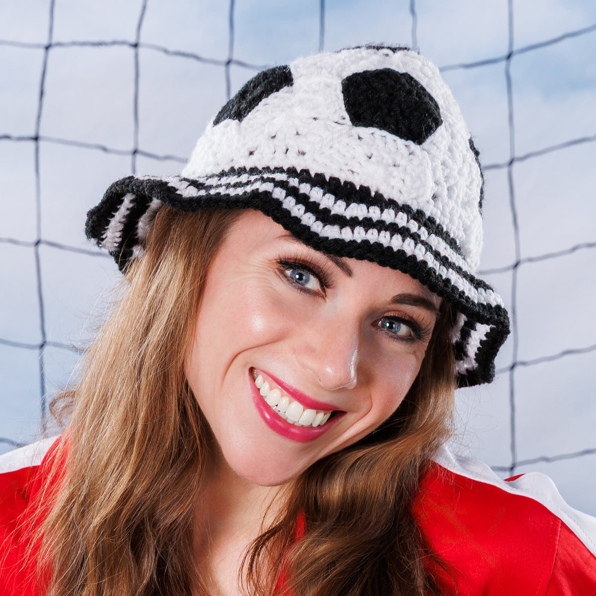 Crochet Soccer Ball Hat made using Red Heart yarn in a styled lifestyle setting